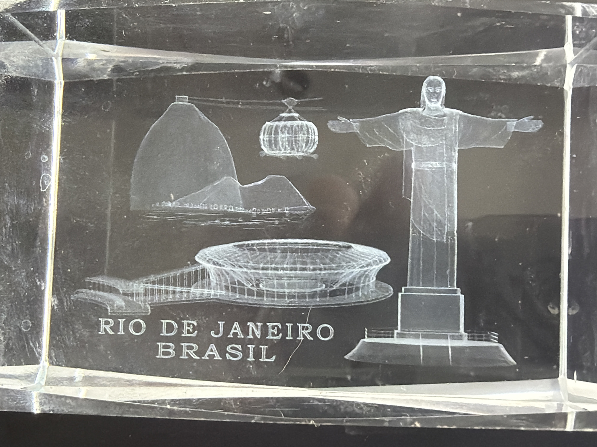 The image depicts a clear acrylic cube featuring laser-etched iconic landmarks associated with Rio de Janeiro, Brazil. These include the Sugarloaf Mountain, the Christ the Redeemer statue, and what appears to be the Niterói Contemporary Art Museum designed by Oscar Niemeyer. Etched below the illustrations are the words "RIO DE JANEIRO BRAZIL". No aspects of Burgas, Bulgaria are depicted or present.