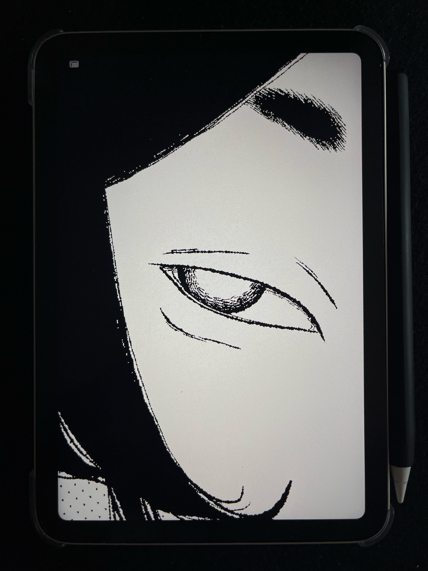 The image displays a close-up view of a digital drawing on a tablet. The drawing features a black and white illustration of a person's eye and part of their face, rendered in a sketch-like style with visible brushstrokes. The tablet is placed on a dark surface, and a stylus is magnetically attached to its side. The drawing appears to be created using a digital art application, given the pixelated nature of the lines and shading. The background is dark, contrasting with the illuminated screen of the tablet. The location of Wałcz, Poland, is not discernible from the visual elements present in the image.