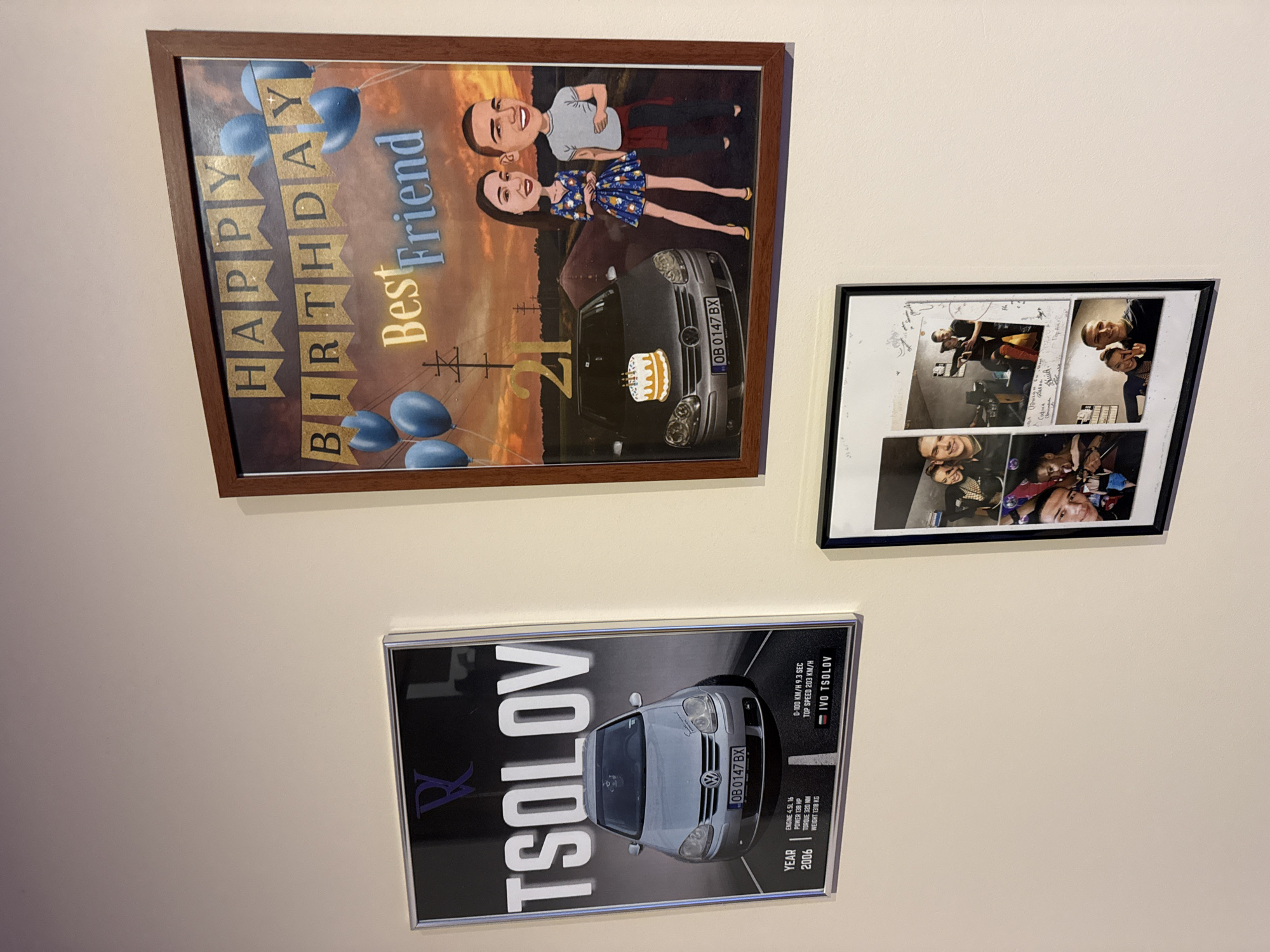 The image shows three framed posters hanging on a light-colored wall.
The top left poster has a brown frame and features a "Happy Birthday Best Friend" message, with the number 21 incorporated. There's a cartoon-style drawing of a couple and a car with the license plate "OB 0147 BX", a Bulgarian plate.
The poster on the right has a black frame and contains a collage of black-and-white photographs with signatures written over them.
The bottom poster is in a silver frame and features a car with the same license plate, "OB 0147 BX." The poster is labeled "TSOLOV" and lists car specifications like engine, power, torque, weight, and top speed. It also states "YEAR 2006" and "IVO TSOLOV."
Based on the license plate code "OB," it can be inferred that the location is related to the city of Lovech, Bulgaria.