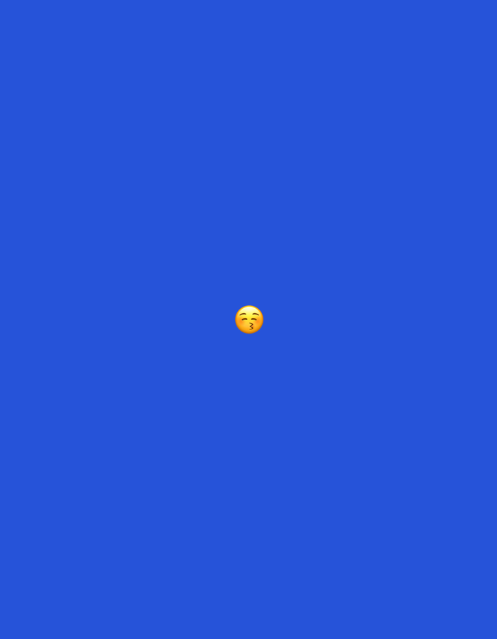 A close-up, centered shot displays a single yellow emoji with pursed lips and rosy cheeks, commonly known as the "kissing face" emoji, set against a solid, vibrant blue background. The emoji is the sole discernible subject in the frame. The overall composition is minimalist and lacks any environmental context, urban setting, or geographical indicators that would place it in Moscow, Russia, or any other location. There are no people, objects, or actions present beyond the digital representation of the emoji.