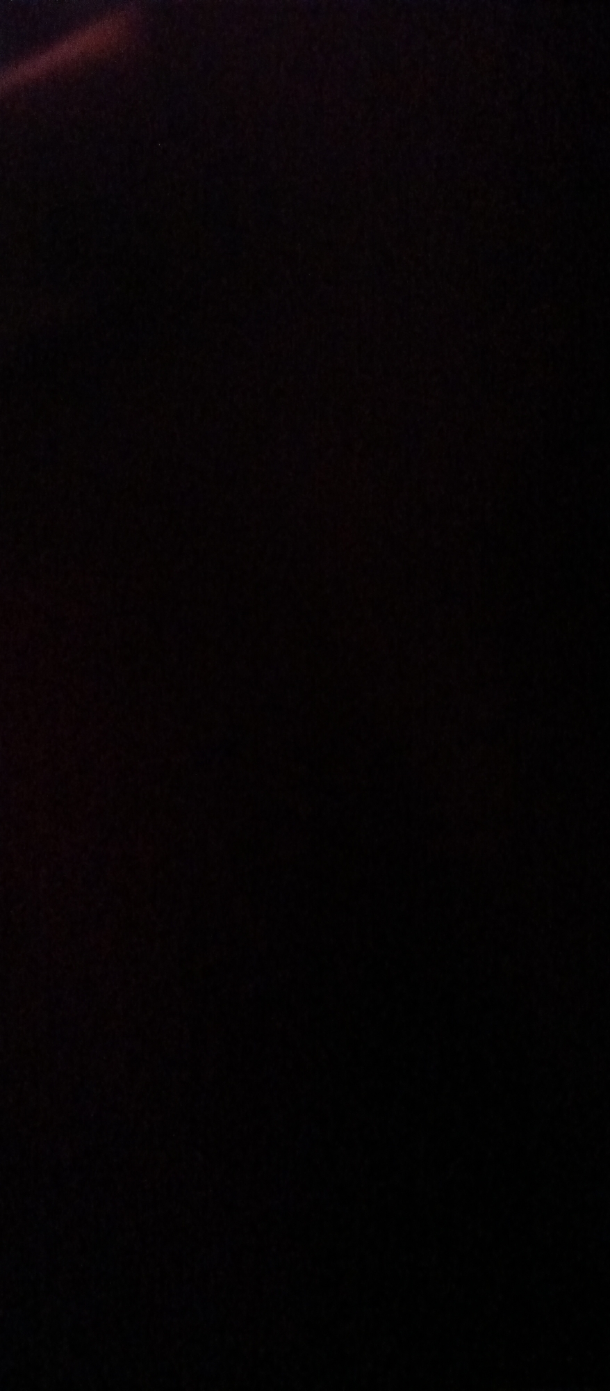 The image is predominantly dark, with a faint reddish-brown diagonal streak visible in the upper left quadrant. The rest of the image is a uniform, deep black, suggesting a low-light or underexposed scene. There are no discernible objects, people, or environmental details within the frame. The location in Sekarpuro, Indonesia, is not visually represented in the image.