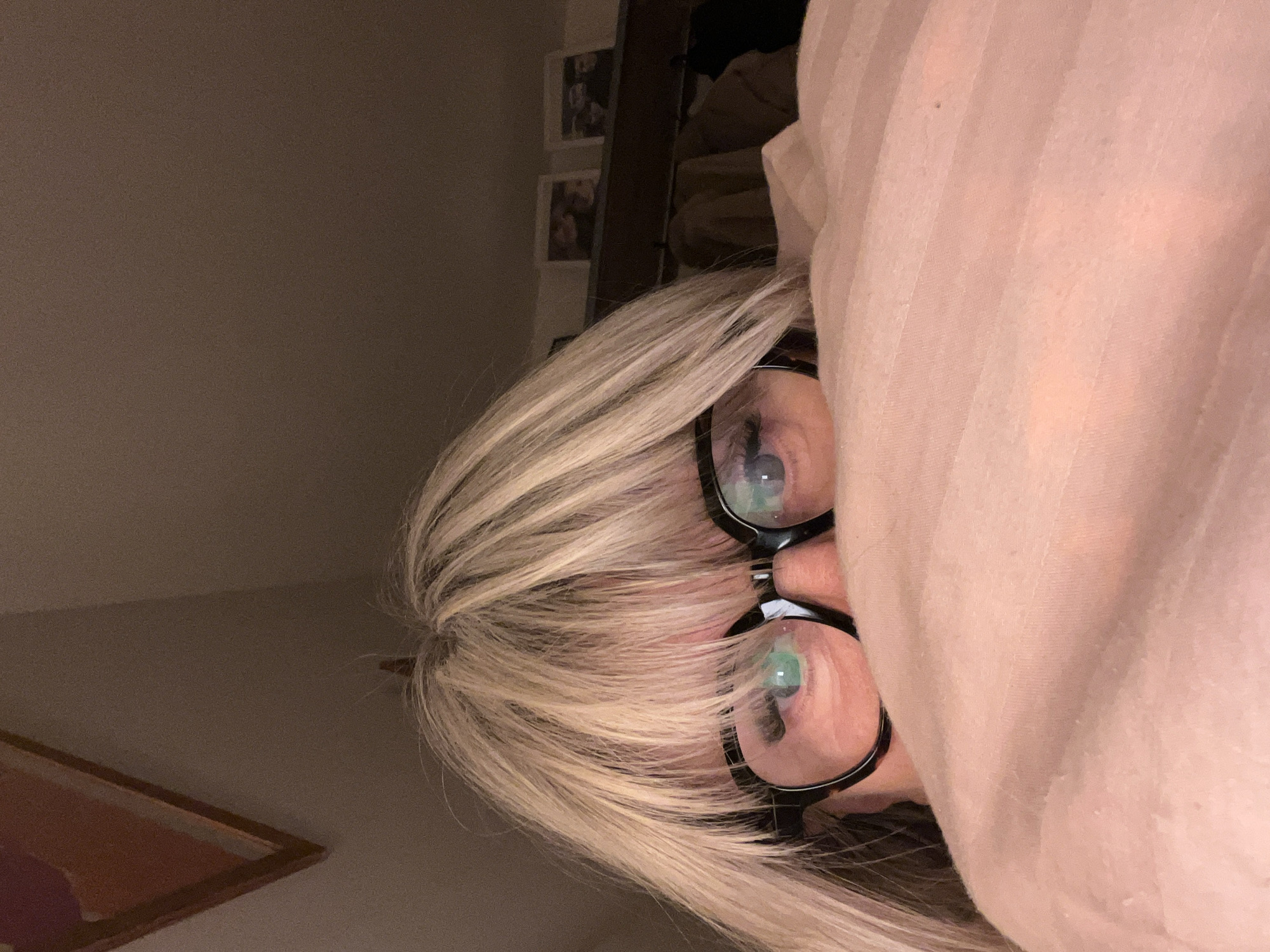 A person with blond hair and glasses is partially obscured by a pink striped fabric, possibly a blanket or sheet. The location is not specified, and there is no indication of the city of Chambœuf, France in the provided image.