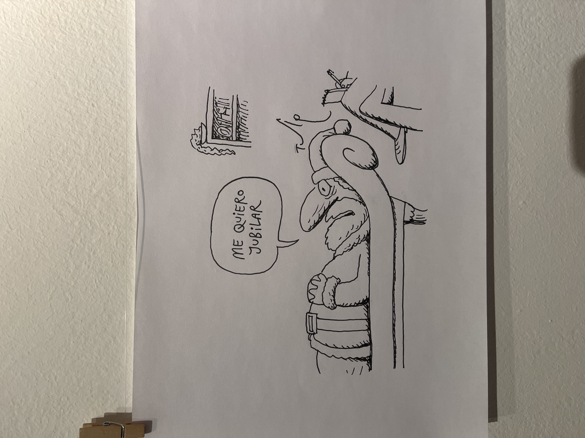 The image is a black and white drawing on a piece of paper, depicting a cartoon Santa Claus figure with a large nose and a long beard. Santa is holding a staff. A speech bubble next to him contains the text "ME QUIERO JUBILAR," which translates to "I want to retire." Above and to the right of Santa, partially visible, is an image of someone lounging in a chair with a lit cigarette. In the upper left corner, there is a small drawing of what appears to be a windowsill. The paper is hanging on a white wall with the aid of a pair of clamps. The location, Buenos Aires, Argentina, is not identifiable from the image.