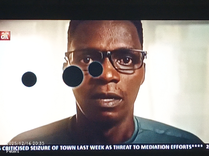 A close-up shot features a man with dark skin and short hair, wearing glasses. The "alt" logo is visible in the upper left corner of the image. The bottom of the screen displays a news ticker: "2025/12/16 20:35 CRITICISED SEIZURE OF TOWN LAST WEEK AS THREAT TO MEDIATION EFFORTS**** 2 Peters." The man's face is the primary focus, and he appears to be speaking.