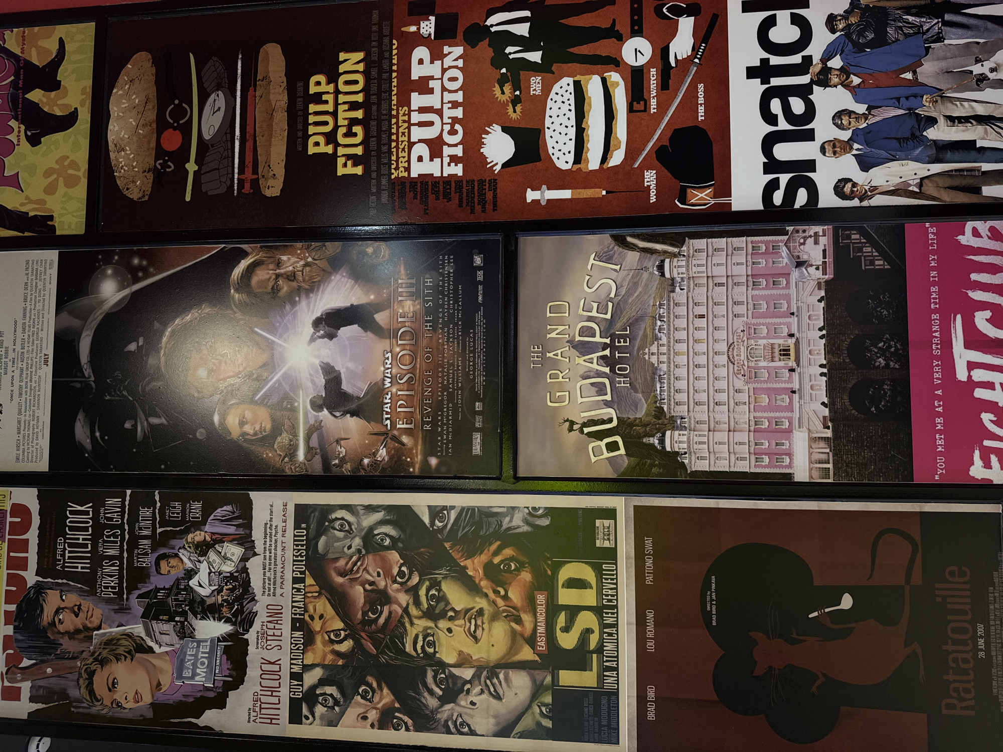The image shows a collection of movie posters. The posters visible include "Pulp Fiction," "Snatch," "Star Wars Episode III: Revenge of the Sith," "The Grand Budapest Hotel," "Fight Club," "Psycho," "LSD Una Atomica nel Cervello," and "Ratatouille." The posters appear to be displayed in rows and columns. No location information is available in the image.