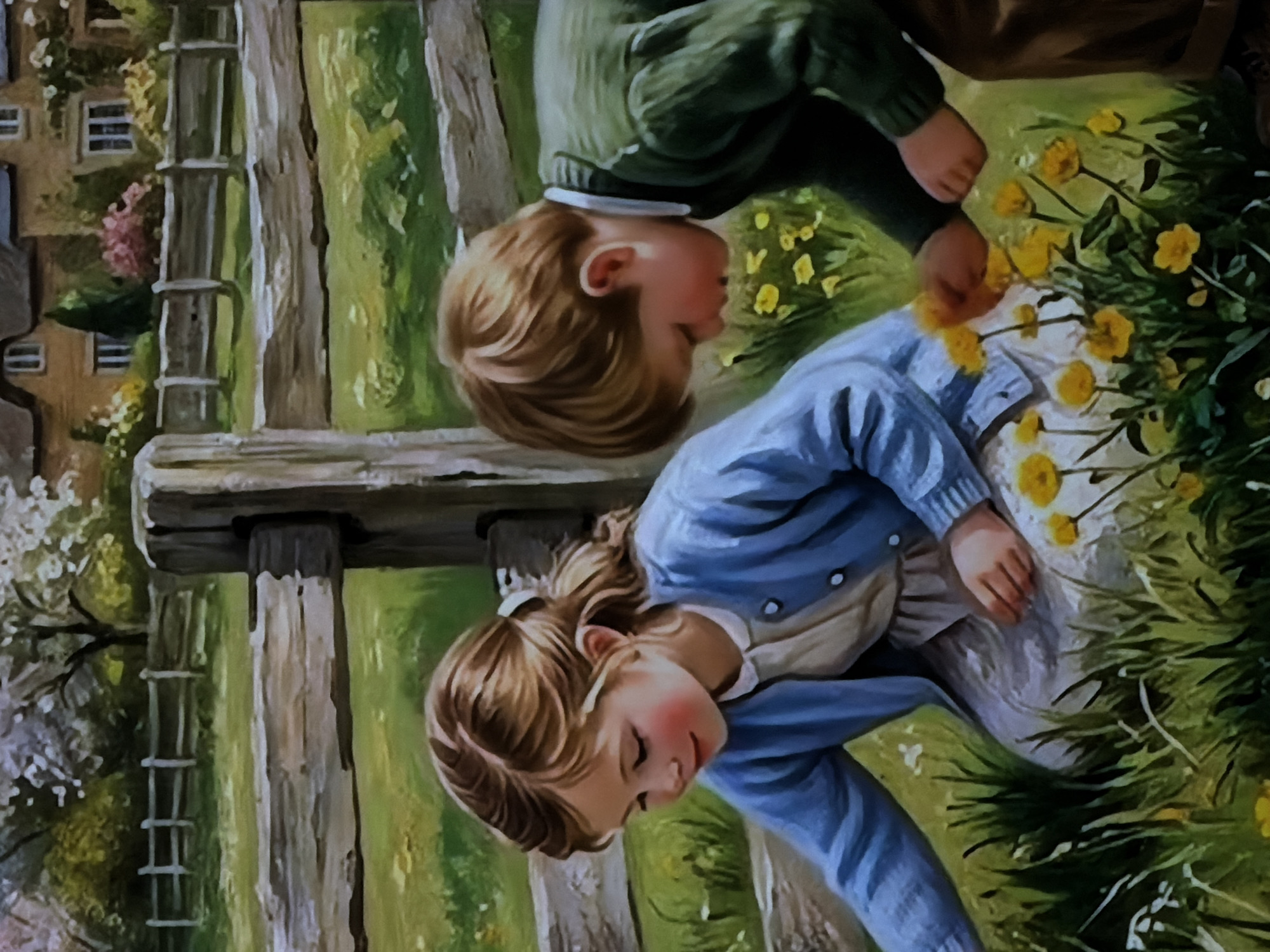 This media file is a painting depicting an idyllic outdoor scene featuring two young children, a boy and a girl, interacting with nature.
The scene takes place in a sunny, pastoral setting, likely a garden or countryside field. A rustic wooden fence runs across the mid-ground, providing a visual boundary. In the background, a traditional-style house with multiple windows and warm-toned walls is partially visible, nestled amidst trees and flowering bushes.
In the foreground and mid-ground, the two children are the central subjects. The boy, positioned slightly higher and further back, wears a green long-sleeved sweater and brown trousers. He has light brown hair and is depicted bending over, focused on a patch of bright yellow flowers in the grass. His hands are positioned as if he is about to touch or pick them.
The girl, closer to the viewer, wears a blue long-sleeved cardigan over a lighter-colored top and a beige skirt. Her light brown hair is styled, and she also leans down, engrossed by the yellow flowers directly in front of her. Her cheek shows a slight rosy blush. Both children appear engaged in a moment of quiet observation or play with the flowers, suggesting curiosity and innocence.
The ground is covered in lush green grass dotted with numerous yellow blossoms, possibly dandelions or buttercups. The overall impression is one of a bright, pleasant day. There is no visible text in the image. The art style is traditional, resembling an oil or acrylic painting with visible brushwork. The image itself was provided from a location context of Sofiivska Borshchahivka, Ukraine.