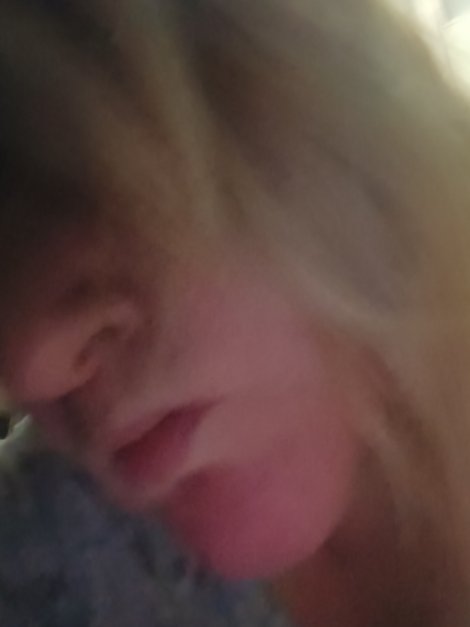 A close-up, blurry image of a person's face showing the nose, mouth, and chin. The face is tilted downward and to the side. The person has blonde hair. The background is indistinct. It is not possible to determine the location within Верхнесадовский округ, Ukraine, or any specific details about the environment or actions.