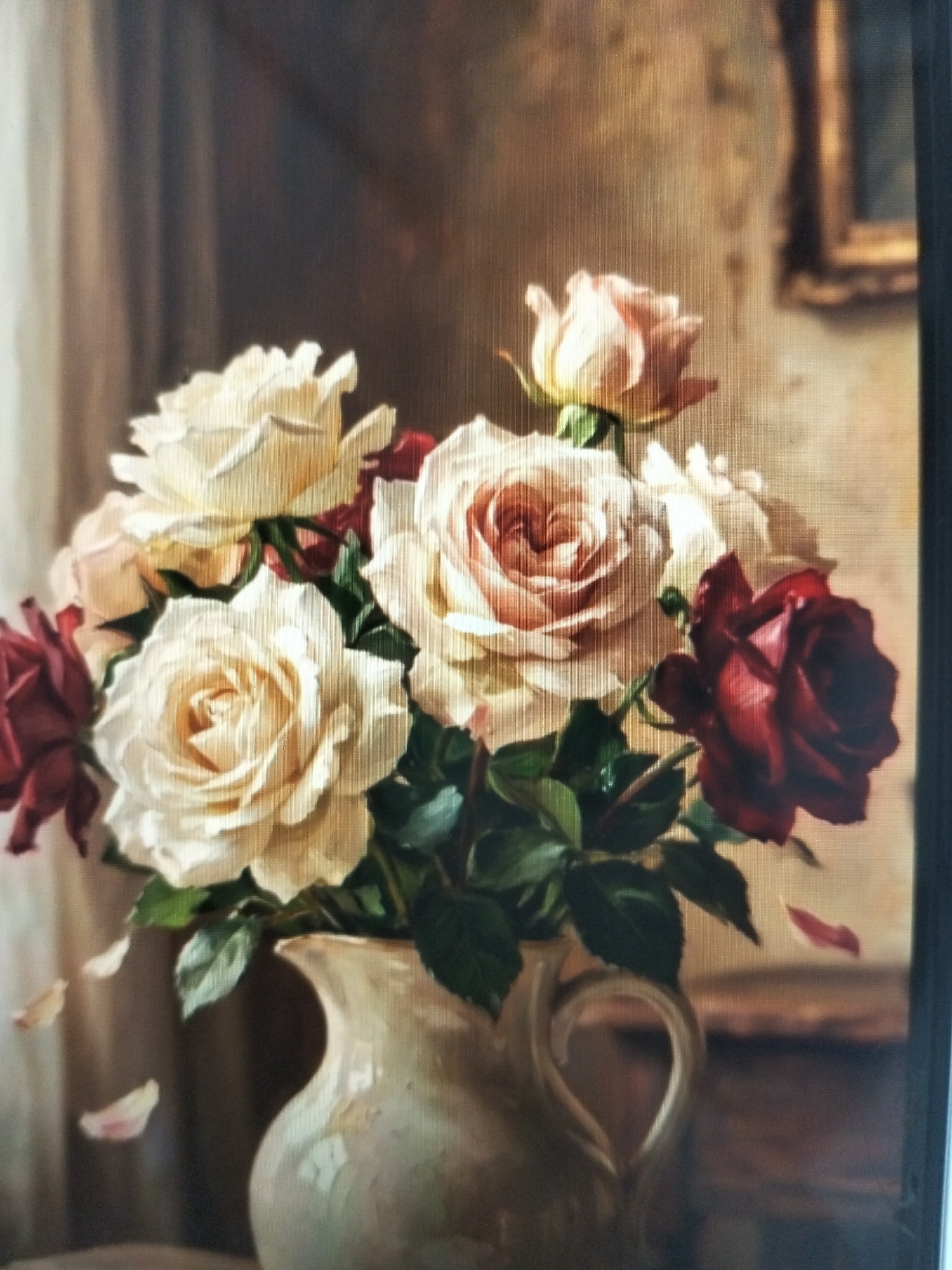 This is a close-up, high-angle photograph of a still life painting of a floral arrangement. The painting features a bouquet of roses in various shades of cream, pink, and deep red, arranged in an off-white ceramic pitcher. The pitcher has a distinctive curved handle and appears to be slightly textured. Several rose petals are depicted falling from the bouquet, some resting on the surface below. The background of the painting is muted, with a suggestion of drapery on the left and a framed picture or window on the right, rendered in warm, earthy tones. The overall impression is of a classical, softly lit composition. There are no people or any identifiable elements of a city, including Payagaboh, Indonesia.