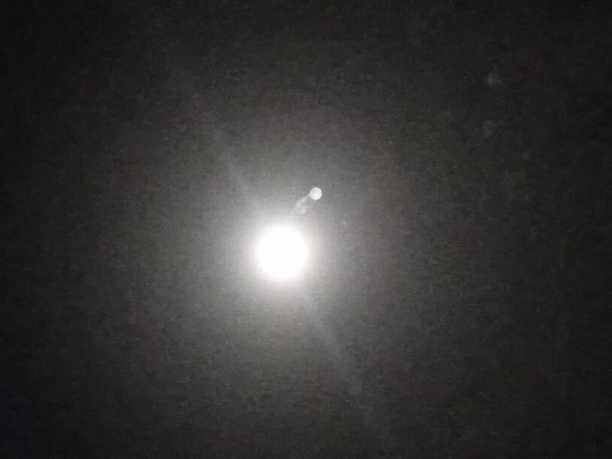 The image depicts a night scene in Nata-Ala, Nigeria. A bright, full moon dominates the center of the frame, radiating light across the dark sky. No people, objects, or specific environmental features are discernible other than the night sky.