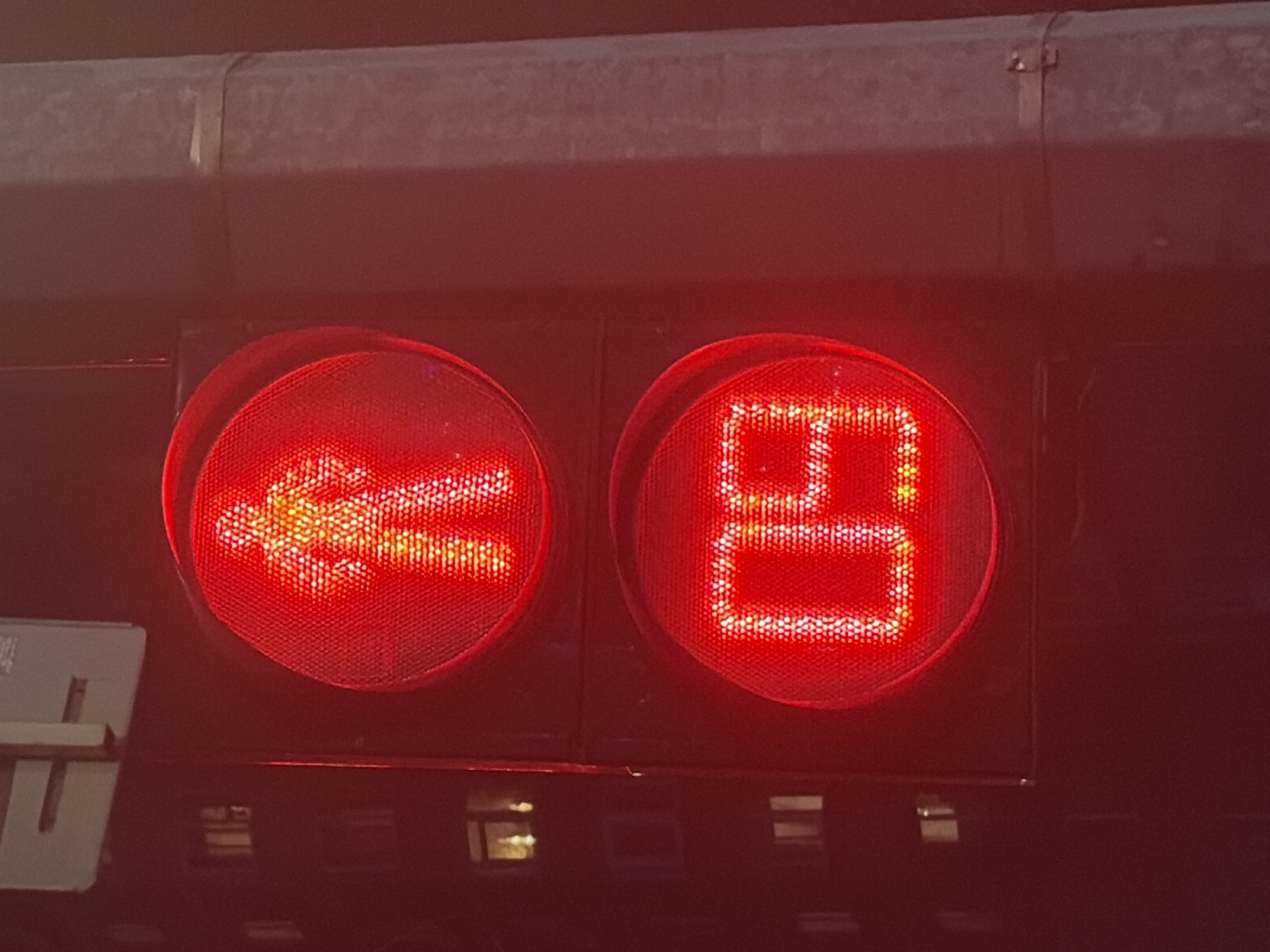 The image shows two red illuminated signs on the back of a vehicle. The left sign displays a left-pointing arrow, while the right sign shows the Russian letter "Я". The vehicle is located in Perm, Russia.