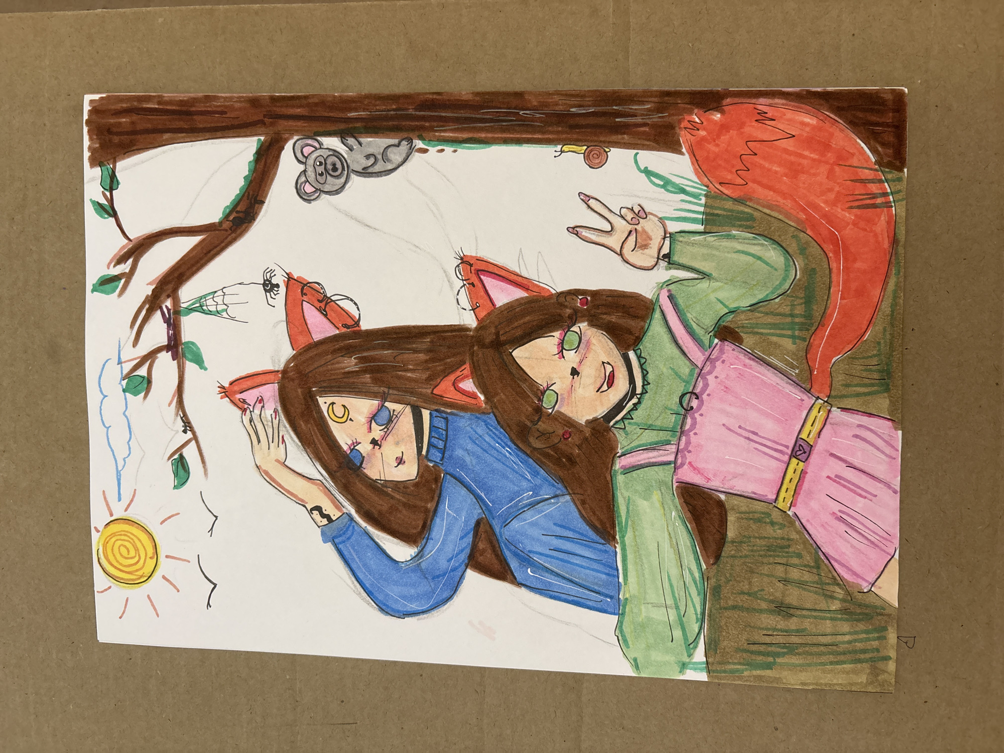 Two young women with fox ears are depicted in an illustration. The woman on the left wears a blue sweater and has a crescent moon mark on her forehead. The woman on the right wears a green dress and has a pink sash around her waist. Her fox tail is red. They are underneath a tree branch with a koala, a snail, and a spider web. The sun is in the lower-left corner. The background is white. There is no indication of the location being Saint Petersburg, Russia.
