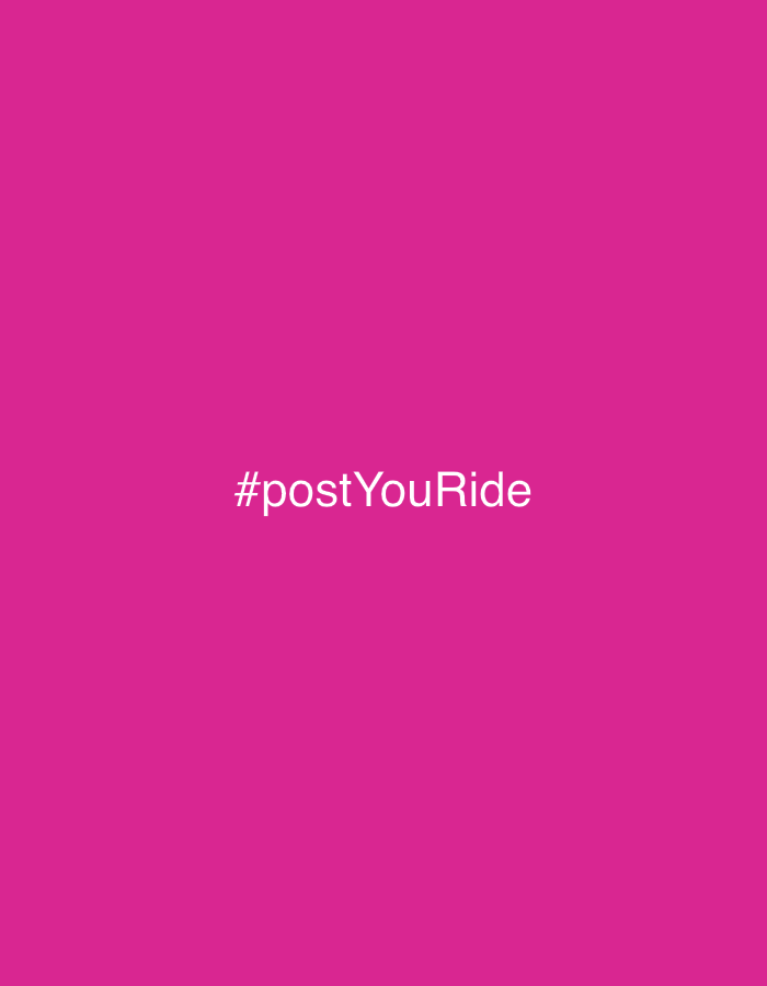 The image is a minimalist graphic featuring a solid, vibrant magenta background. Centrally placed on this background, in a clean, white sans-serif typeface, is the hashtag "#postYouRide". No other subjects, such as people or objects, are visible. The scene is devoid of any specific setting, activity, or event, focusing solely on the text against the monochromatic backdrop. There are no notable details regarding time of day, weather, or discernible emotions. The image functions as a textual graphic, likely for a social media campaign or promotional material. This graphic is associated with the location context of Abuja, Nigeria. The provided cropped images confirm the uniform color and text placement, offering no additional visual information.