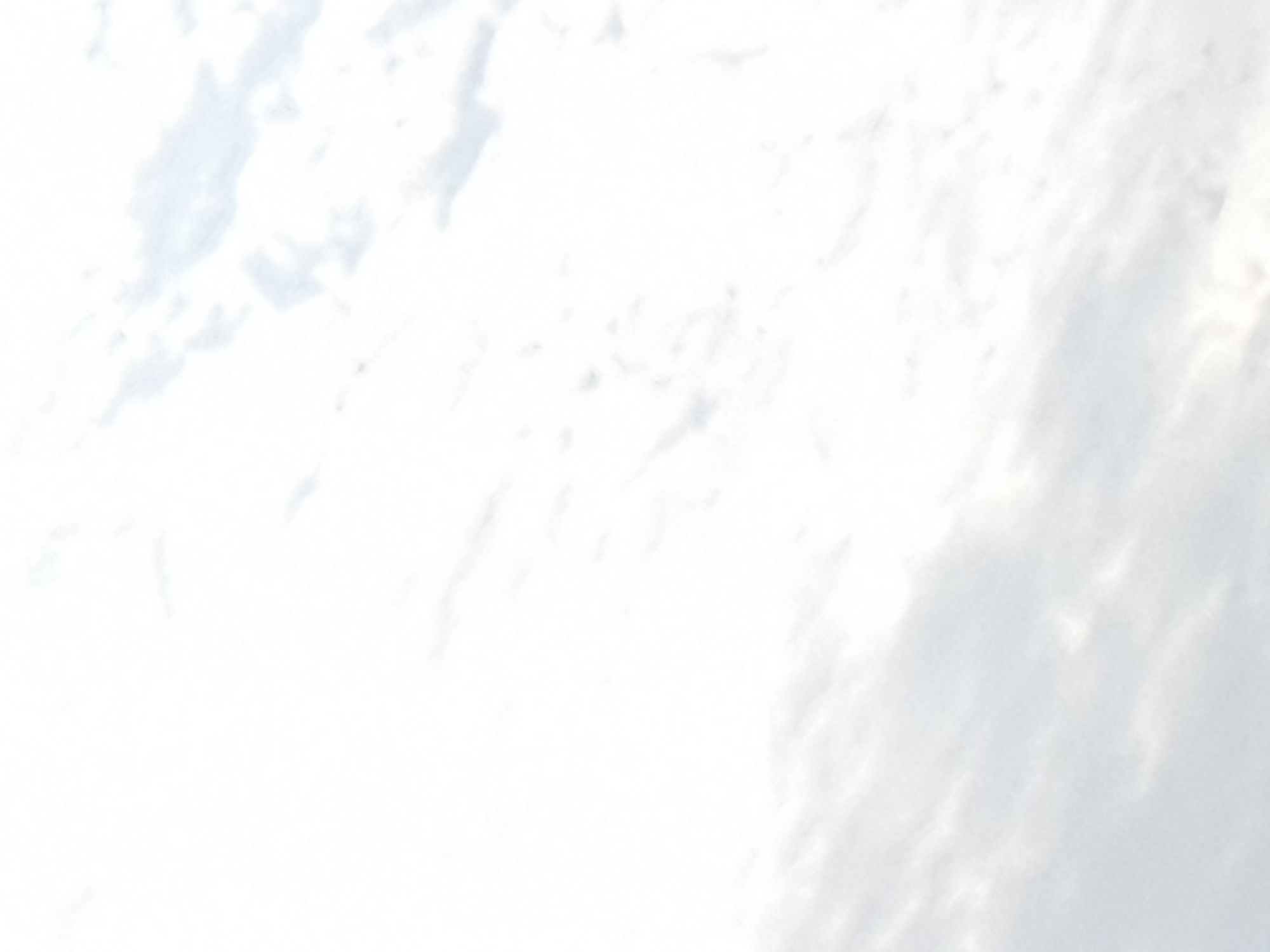 The image displays a bright, overcast sky filled with diffused sunlight and scattered clouds. The clouds are predominantly white with subtle gray undertones, creating a soft, textured appearance. The lighting suggests it is daytime, but the overcast conditions prevent harsh shadows. The scene appears to be an outdoor environment, likely captured from the ground looking upwards. There are no discernible structures, people, or specific landmarks that would pinpoint a location within Gura Top, Nigeria. The image is abstract and lacks specific identifying features.