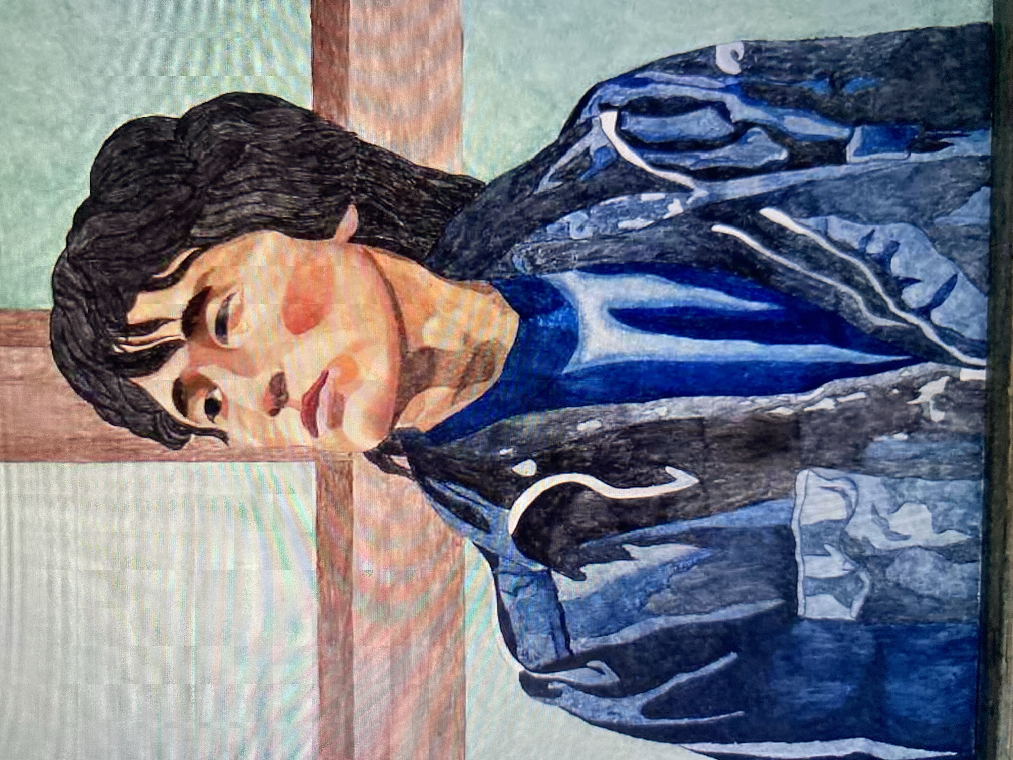 A watercolor portrait depicts a young person with dark, tousled hair and fair skin with rosy cheeks. They are looking upwards and to the left, with their lips slightly parted. They are wearing a dark blue long-sleeved shirt under a dark blue denim jacket with white accents. The background features abstract shapes and colors, suggesting a window frame or architectural elements with a light green and brown color palette. The style is painterly with visible brushstrokes. The image is framed by a dark border at the bottom and top.