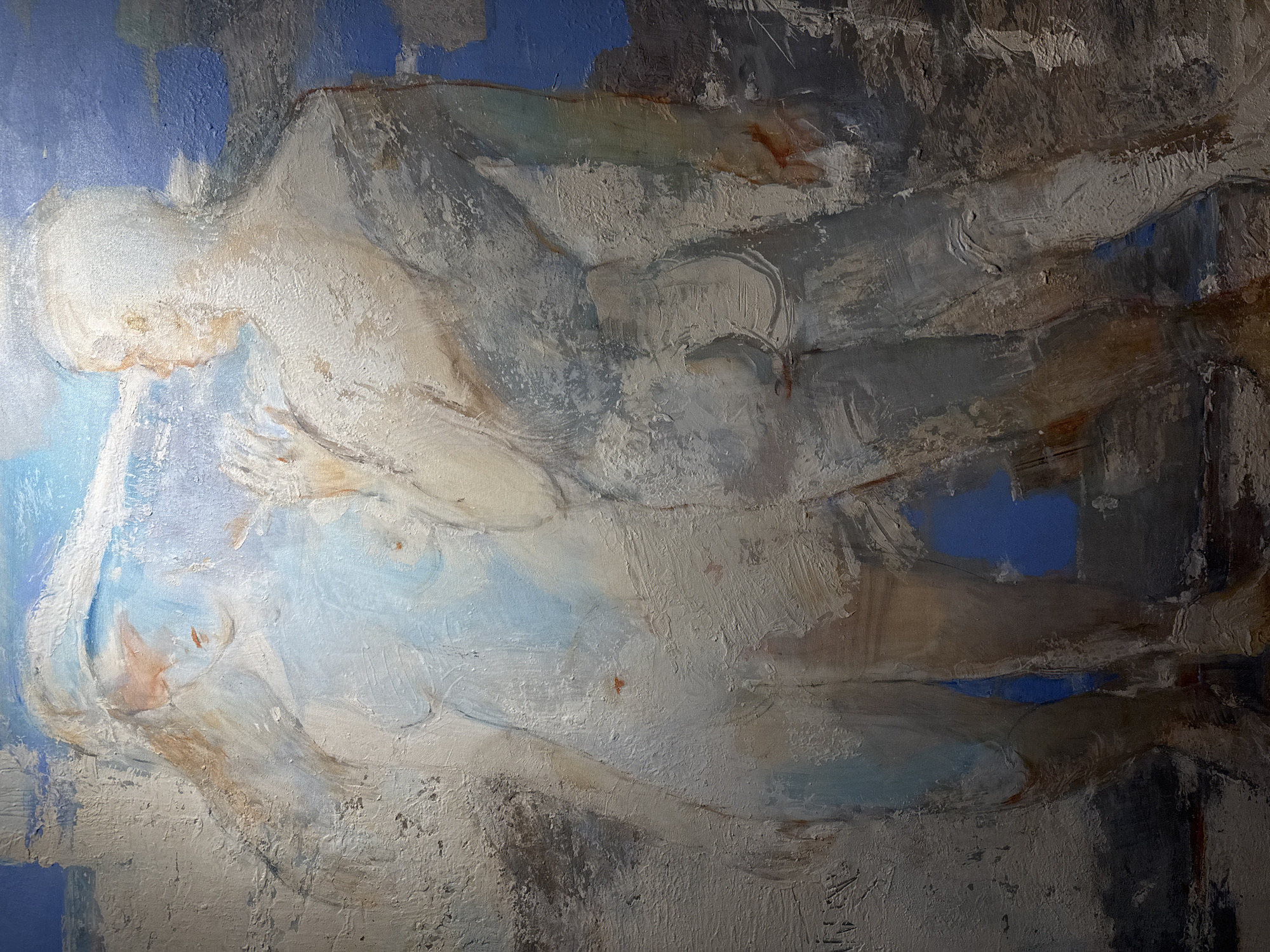 The image is an abstract oil painting depicting a human figure or figures in a reclining position. The color palette is dominated by shades of white, grey, and blue. The brushstrokes are thick and textured, with visible impasto. There is no evidence in the image to locate the scene in the city of Saint Petersburg, Russia.