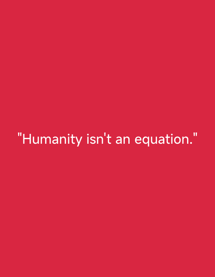 A digitally rendered image displays white text centered against a solid, uniform red background. The text, enclosed in quotation marks, reads: "Humanity isn't an equation." The font is a clean, sans-serif style. There are no other subjects, objects, people, or environmental details present. No specific location information is discernible within the image.
