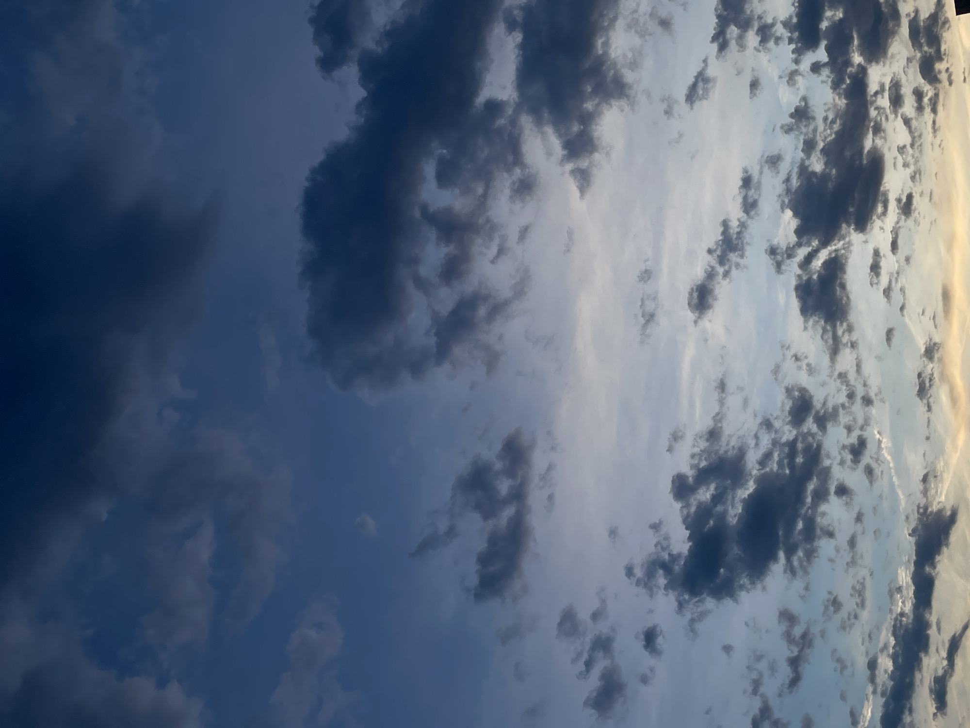 The image depicts a cloudy sky. The colors range from light blues to dark blues and some parts have light yellow colors. It is hard to tell what the exact location is from the picture. The location provided is Belgrade, Serbia.