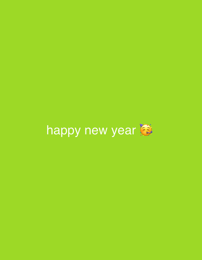 The image is a plain, solid green background with the text "happy new year" in white font. To the right of the text is a cartoonish emoji of a face with puckered lips and a party hat. There is no discernible location in Shumen, Bulgaria, or any other city. The image is a simple digital graphic with no real-world context.