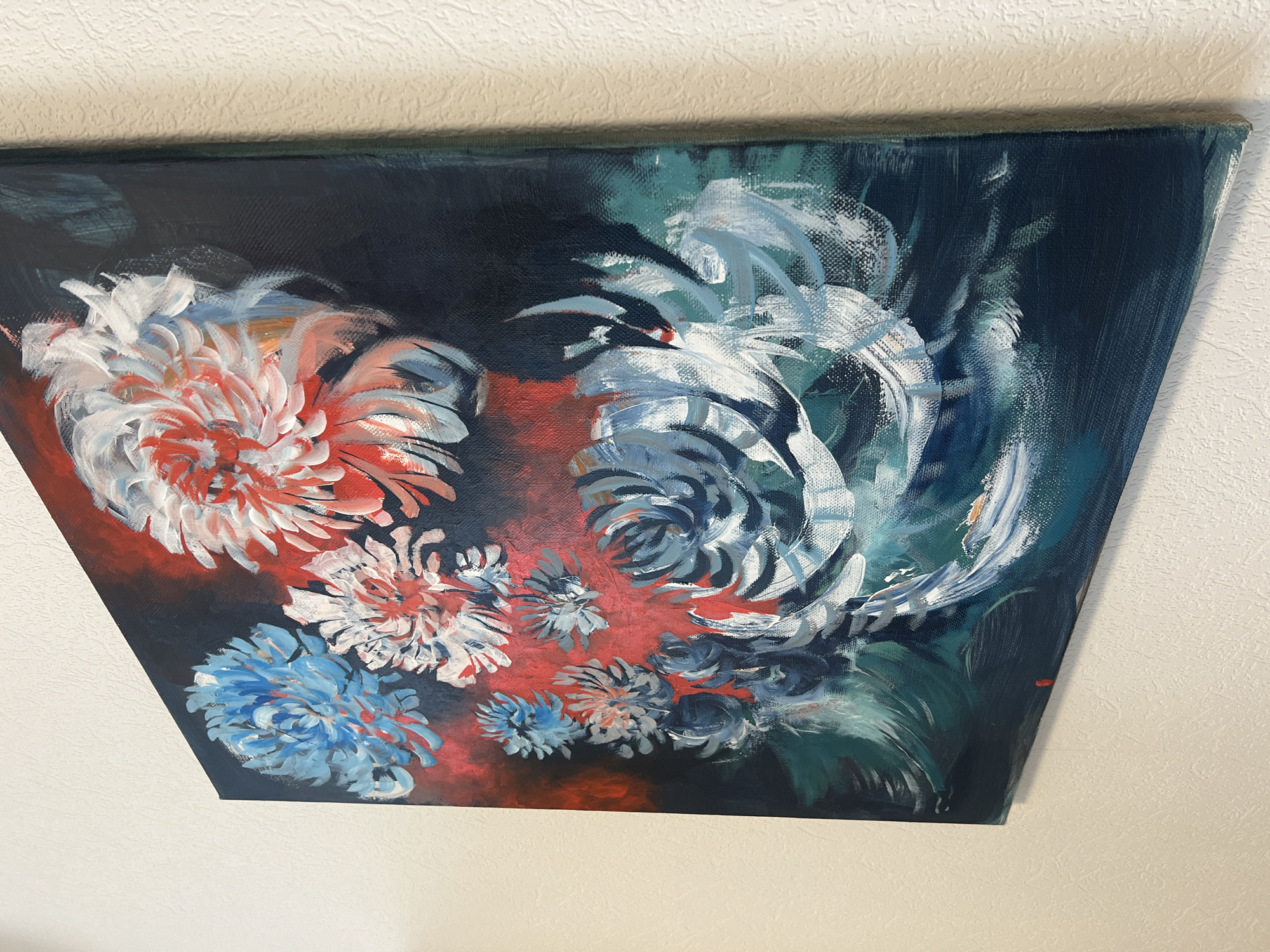 The image shows a painting of flowers with a dark background. The flowers are painted in a loose, expressive style with visible brushstrokes. Colors used include white, red, blue, and green. The painting is mounted on a wall, likely indoors. There is no information in the image that places the location in Tyumen, Russia, or any details about people, actions, or interactions beyond what is depicted in the painting itself.