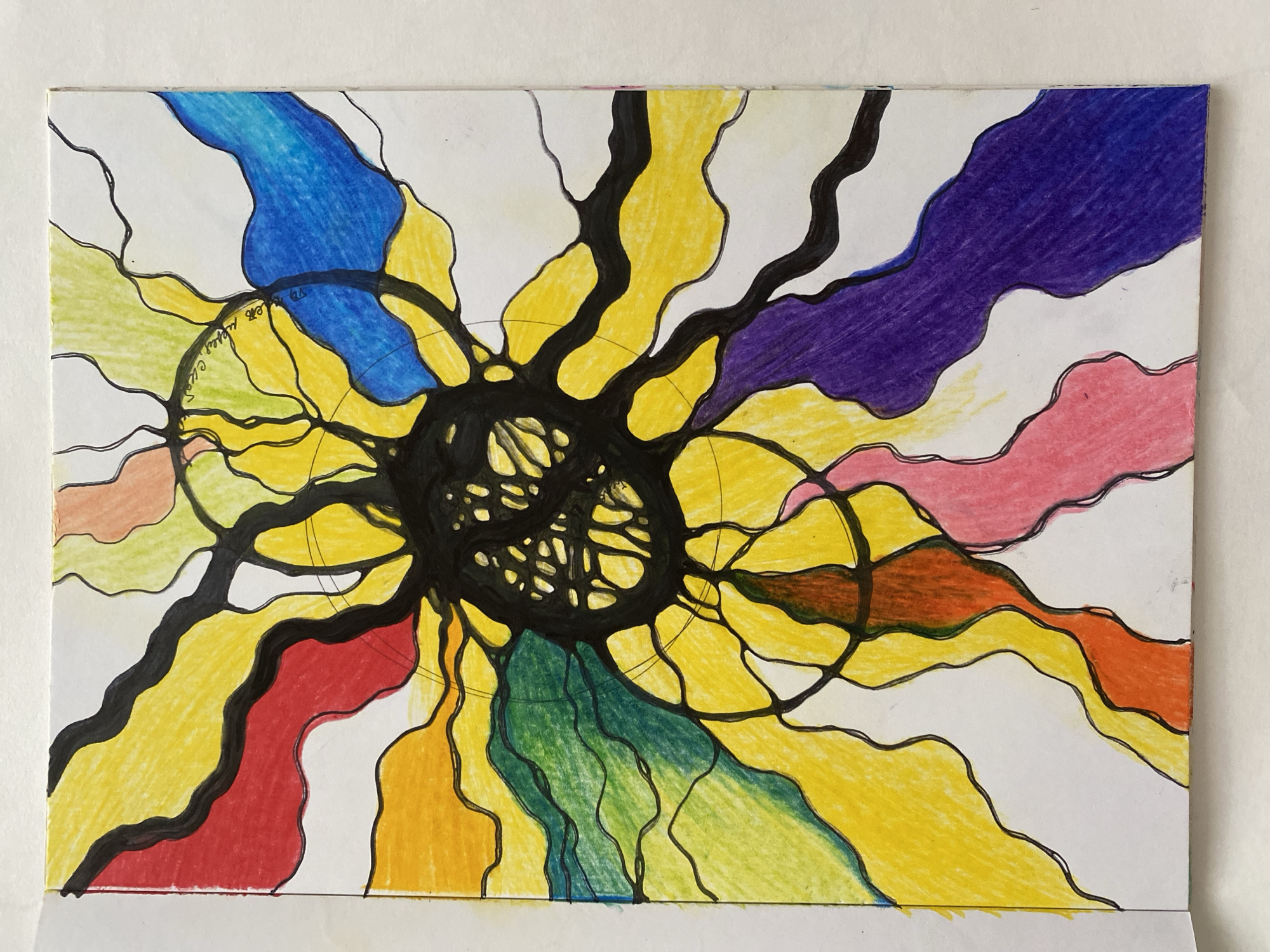 The image is a colorful drawing of an abstract pattern that resembles a flower or a starburst. The drawing is done on white paper and features bold black lines that divide various sections. These sections are filled with colored pencils in shades of red, yellow, orange, green, blue, purple, and pink. The colors are applied in a wavy, organic pattern radiating from a central black mass. The central mass is also delineated with black lines, creating a complex, almost cellular structure. Two circular shapes are present within the drawing, one in the upper right quadrant and another in the lower left quadrant, both outlined in black. The drawing appears to be on the left page of an open notebook or sketchbook. There are no people or any discernible environmental details related to a city location.
