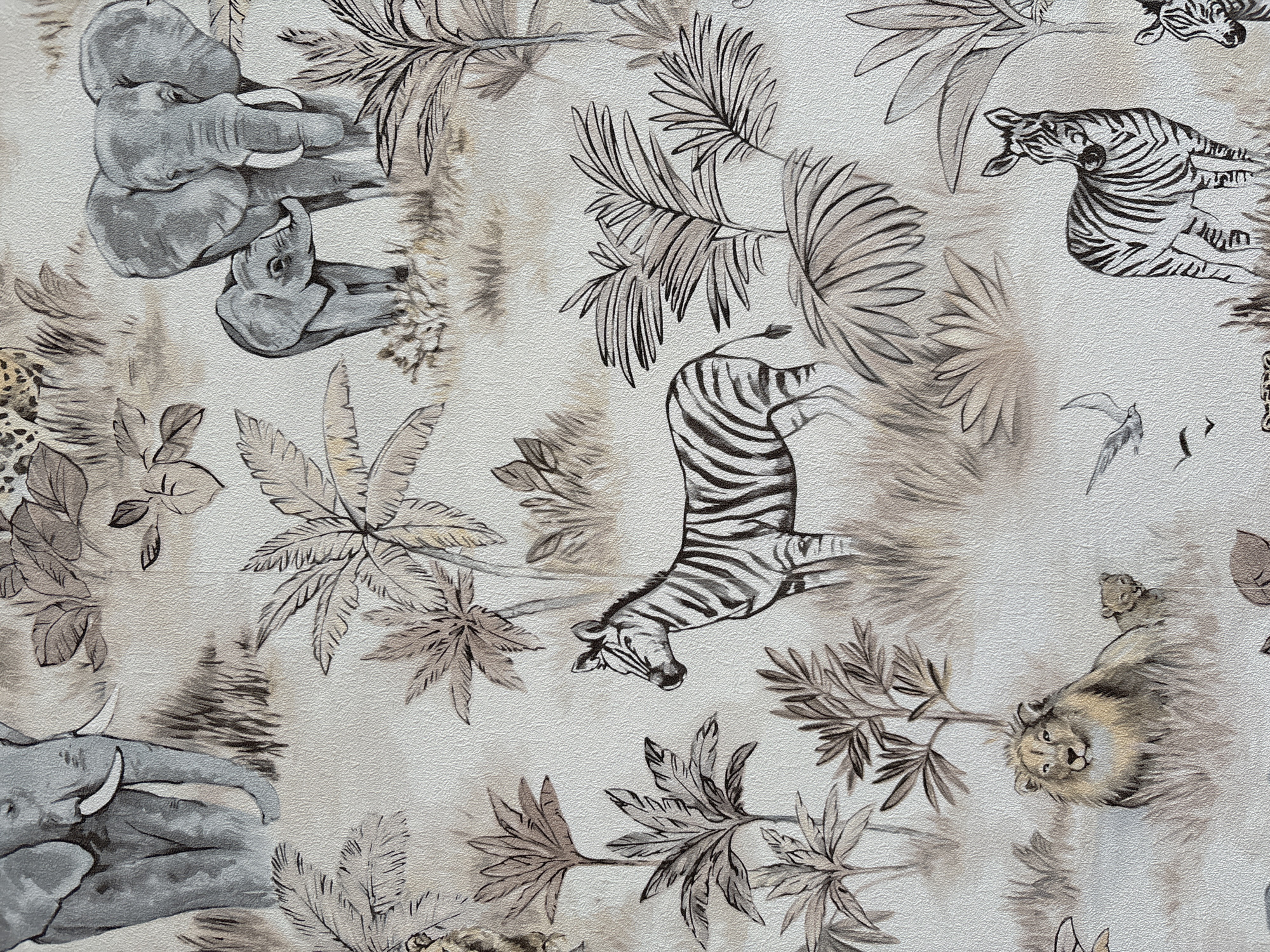 The image is a close-up of a textile with a pattern of African wildlife and vegetation. The wildlife includes zebras, elephants, a leopard, and a lion. The vegetation includes palm trees and other tropical plants. The colors are muted browns, grays, and whites. The texture of the textile is visible. No people are visible. The location is irrelevant to the contents of the image.