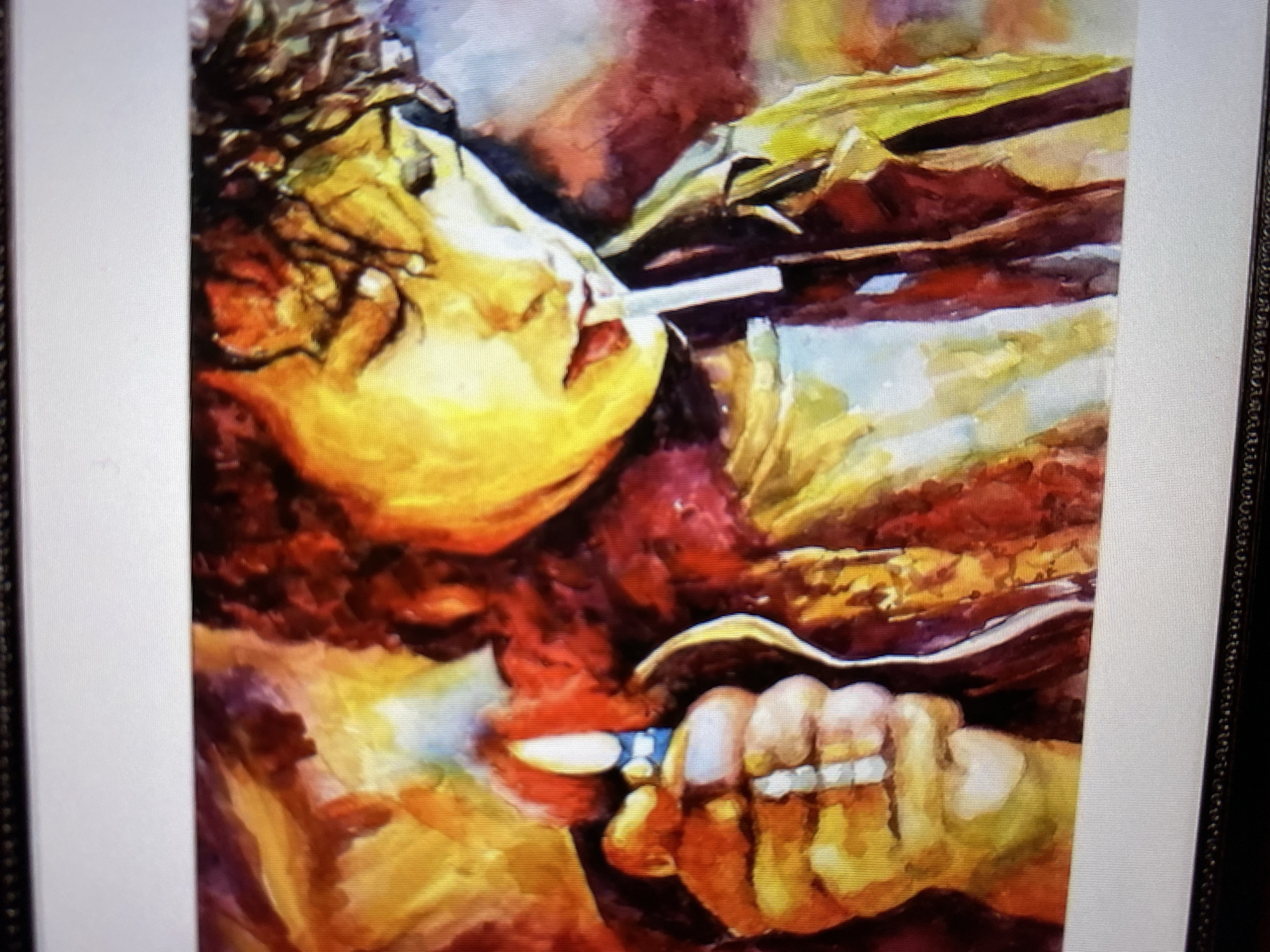 A close-up, low-angle shot shows a watercolor painting of a person's head and shoulders. The subject has curly dark hair and their eyes are closed. They are holding a lit cigarette in their mouth and a lighter in their left hand. The painting uses a vibrant palette of warm colors, including yellows, oranges, reds, and purples, with some areas of blue and white. The brushstrokes are visible, giving the painting a textured and expressive quality. The background is abstract and blends with the subject's clothing and skin tones. The painting is framed by a dark border and a white mat.