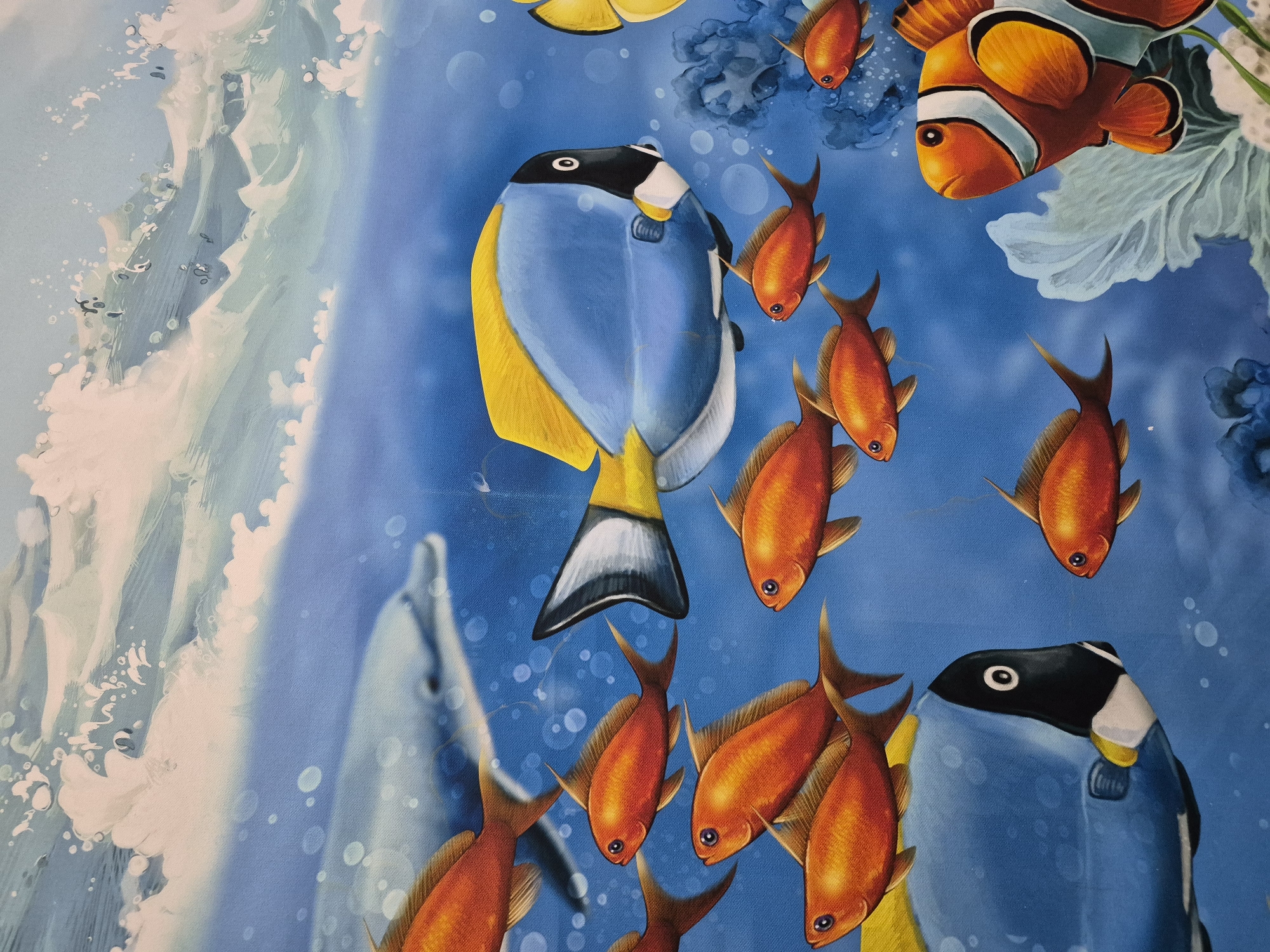 This media file features a vibrant, illustrative depiction of an underwater marine scene. The central subject is a large, brightly colored fish, likely a Powder Blue Tang or similar surgeonfish, with a striking blue body, black head, white markings, and bright yellow dorsal and anal fins. It is positioned vertically, facing the left.
Surrounding the large blue fish are numerous smaller, predominantly orange fish, some with reddish-brown fins, swimming in various directions, adding a sense of dynamic movement. In the upper right quadrant, a prominent orange and white striped Clownfish is visible, characteristic of its species. Another dark-bodied fish, possibly another surgeonfish, with black and white markings on its head, is partially visible in the lower right corner.
The background shows various marine elements: white and light green coral or seaweed-like structures on the right, and faint blue coral clusters elsewhere. On the far left, a large, stylized white wave with splashes suggests the water's surface or a turbulent current. A blurred, greyish shape of a dolphin is faintly visible in the lower-left background, swimming amongst the fish. The water itself is a vivid blue, with numerous small bubbles scattered throughout, indicating an active underwater environment.
The overall impression is that of a colorful, lively coral reef or ocean scene, rendered in a painterly or artistic style rather than a photograph. There is no visible text in the image.