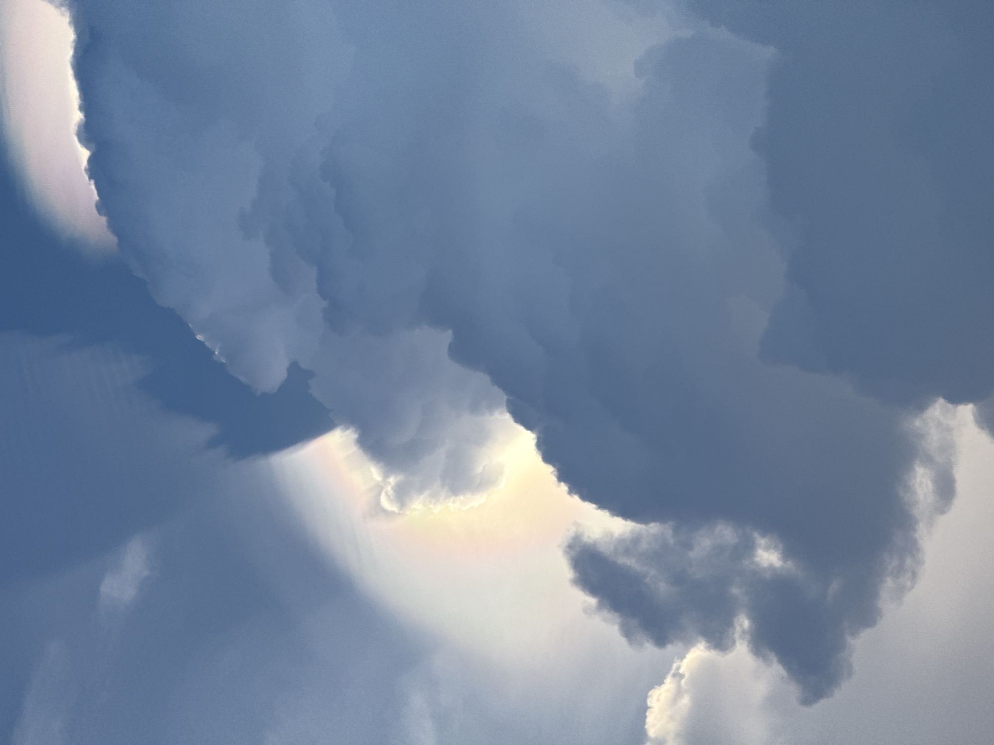 The image depicts clouds in the sky, with portions of the clouds exhibiting iridescence. The exact location in Tây Ninh Hòa, Vietnam cannot be determined based solely on the image.