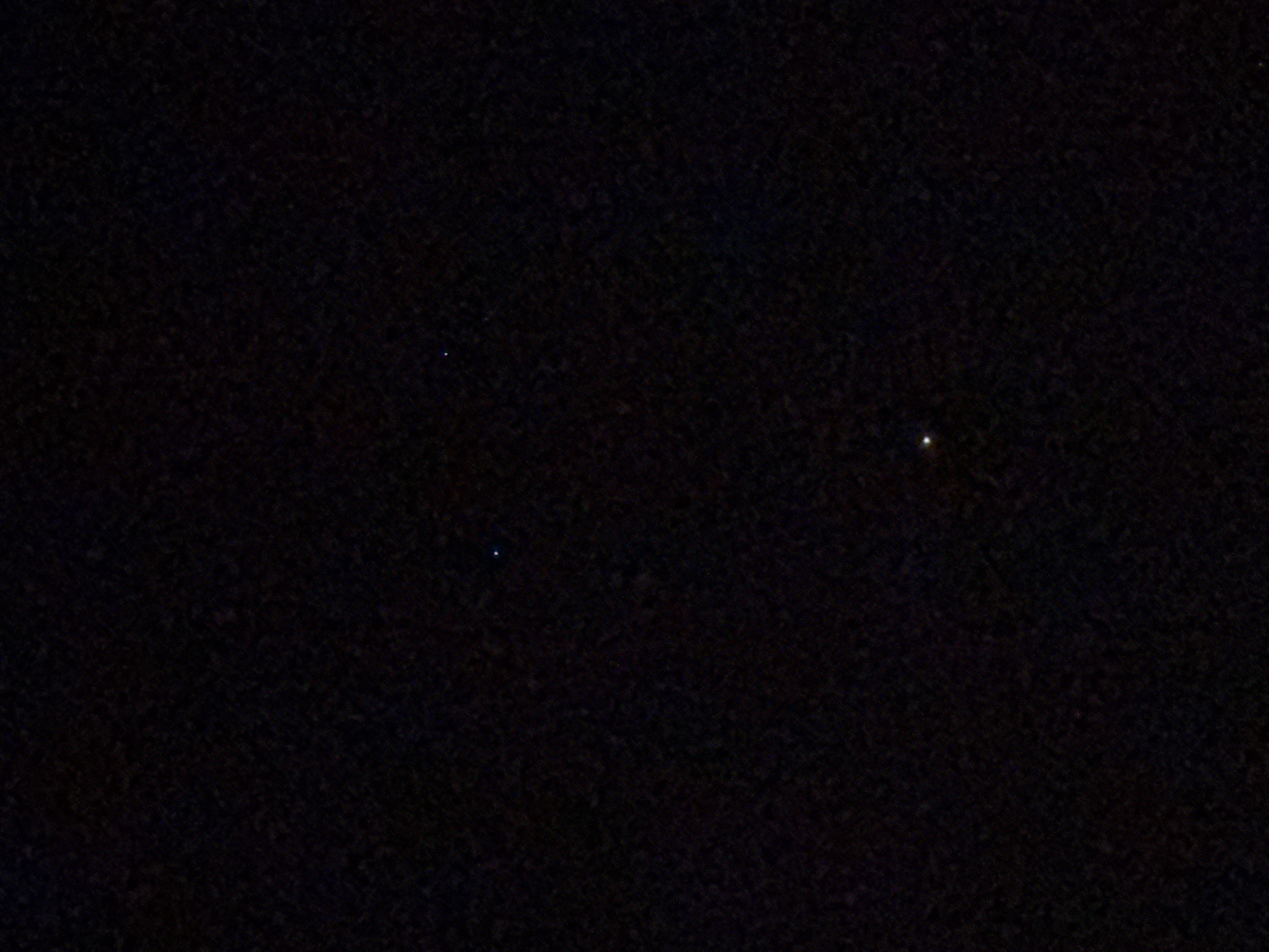 The image appears to be a night sky view. Two small, faint points of light, likely stars, are visible against a dark background. One star is bluish, and the other is yellowish. It is impossible to determine the location of Gorleston-on-Sea or any details regarding people, objects, actions, or interactions without additional information or visual cues within the image.