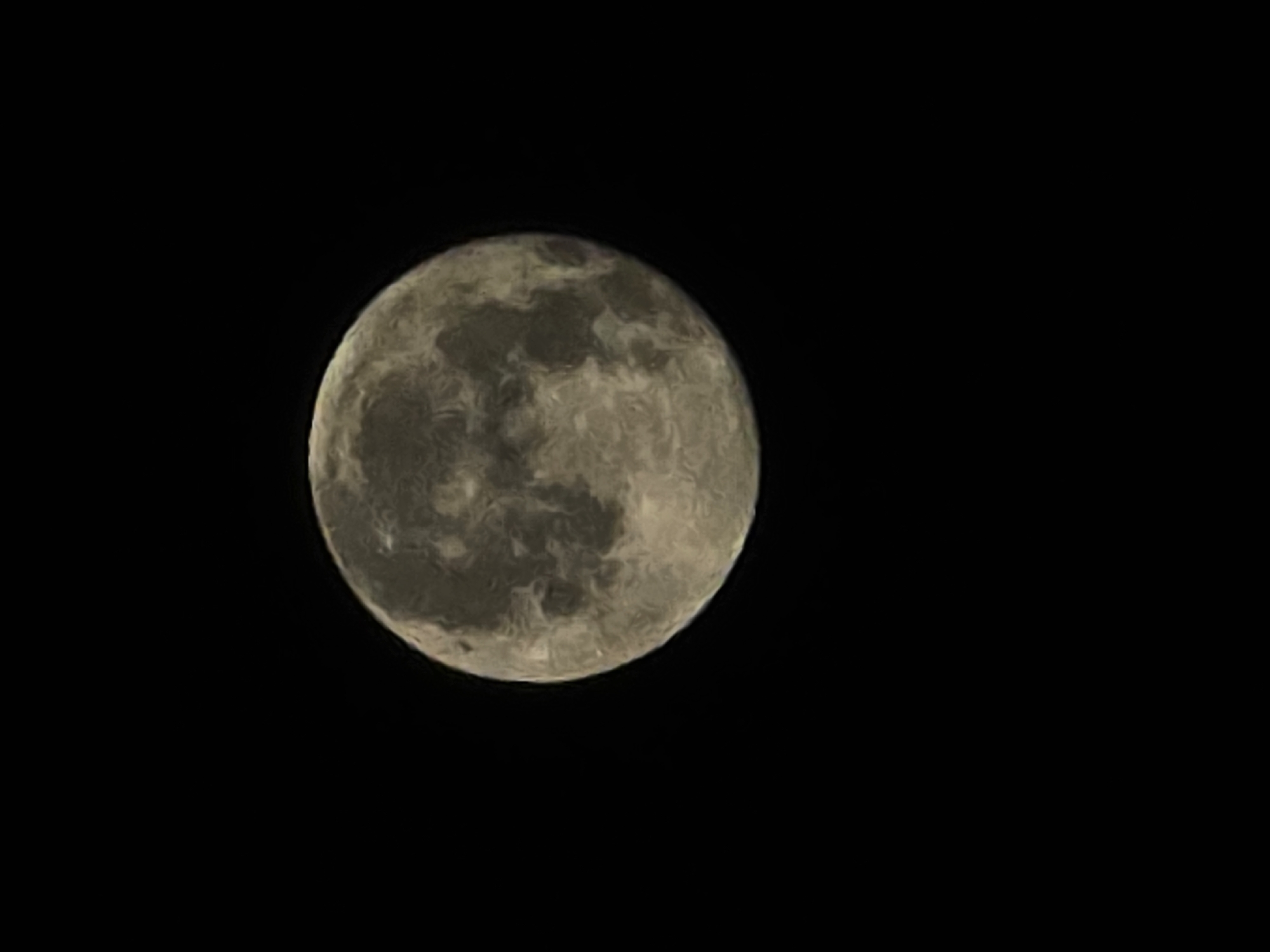 A full moon is centered in a black sky. The moon's surface has visible craters and maria, which are large, dark plains. The lighting on the moon suggests it is illuminated from the left. The image is devoid of any urban or natural landscape features, making it impossible to ascertain a specific location within Yambol, Bulgaria, or any other city. There are no people, objects, or actions depicted.