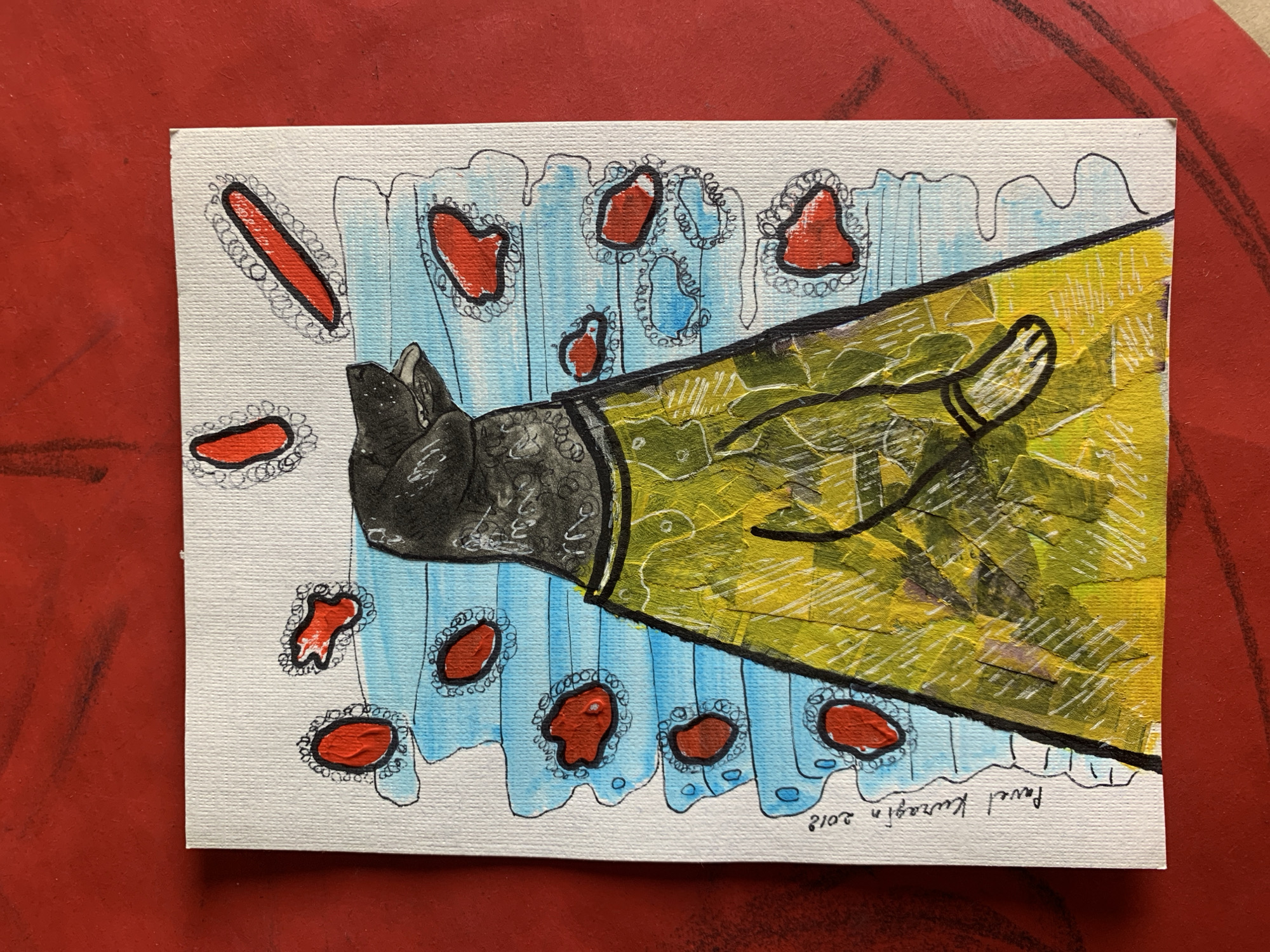 The image is a painting on a white canvas, placed on a red textured surface. The painting depicts a stylized animal, likely a dog, wearing a yellow patterned garment. The background of the painting consists of blue horizontal stripes interspersed with red, irregularly shaped elements, each outlined in black and a decorative, wavy line. The dog has a dark head with its mouth open. Below the dog's head is a suggestion of a collar or neckband. The yellow garment appears to have a textured surface and is adorned with a subtle pattern. The painting is signed on the bottom left in cursive text, "Pavel Kuragin 2018".
The red surface upon which the canvas rests has visible lines or textures, suggesting it might be a table or a piece of fabric with a prominent pattern. The overall aesthetic is abstract and somewhat whimsical. There is no information within the image itself that would suggest a specific location in the city of Sergeevo, Russia.