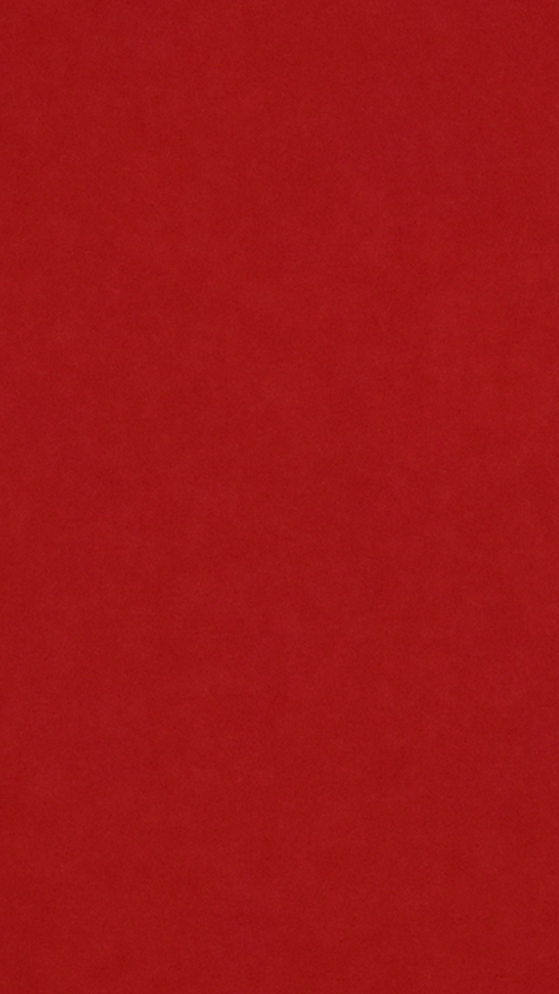 The image is a solid red background. There are no discernable objects, subjects, people, actions, interactions, or environmental details. There is no indication of the location being in the city of Onitsha, Nigeria, or any other location.