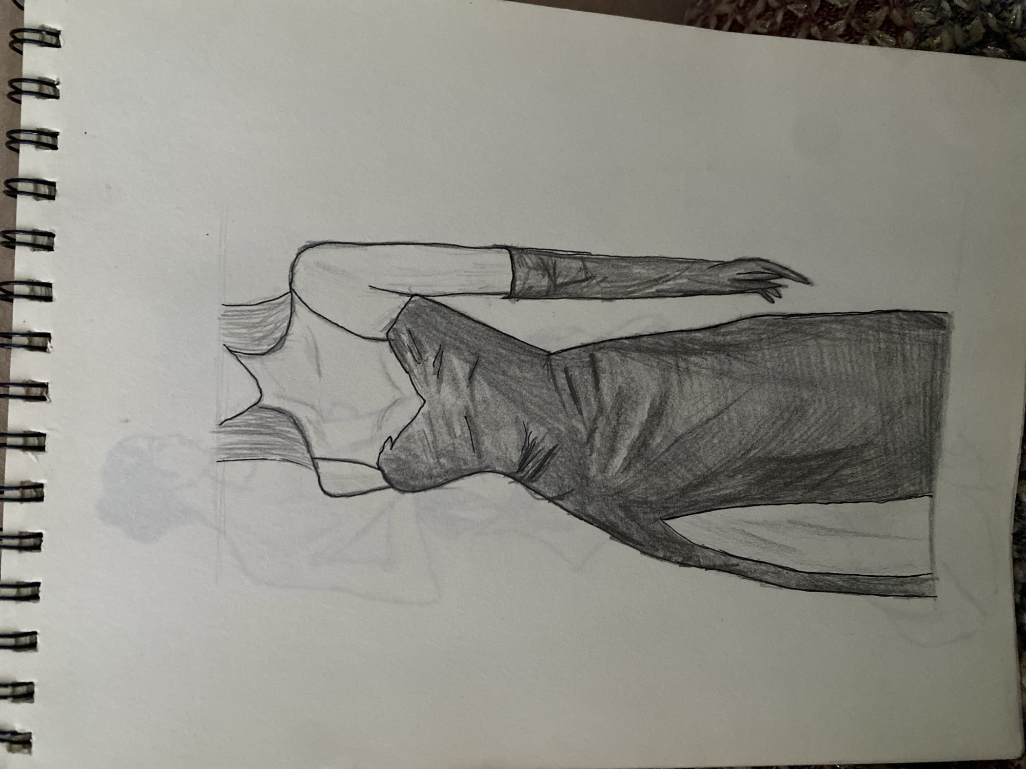A pencil sketch on paper depicts a stylized female figure wearing a long, form-fitting dark dress with a high slit and spaghetti straps. The figure also wears long gloves. A faint outline of another figure is visible behind the main subject. The sketch is bound by a spiral notebook at the top. The background is a plain white surface. There is no indication of the city of Zhmerynka, Ukraine, or any urban environment in this image.