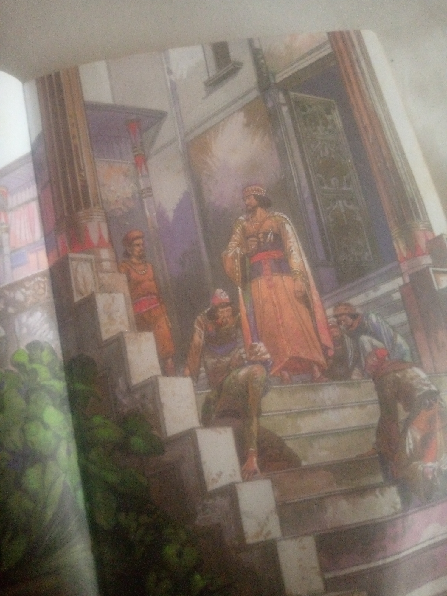 The image depicts a group of people on a grand staircase in what appears to be an ancient or regal setting, possibly a palace or a temple. The architecture features large columns and decorative elements. Several individuals are present, some standing and others seated or kneeling on the steps. They are all dressed in traditional, flowing garments with ornate headdresses and jewelry, suggesting a historical or fantasy theme. The lighting is soft and diffused, creating a somewhat dreamlike atmosphere. The image does not contain any information or visual cues that would allow for its specific placement in Jauro Yinu, Nigeria.