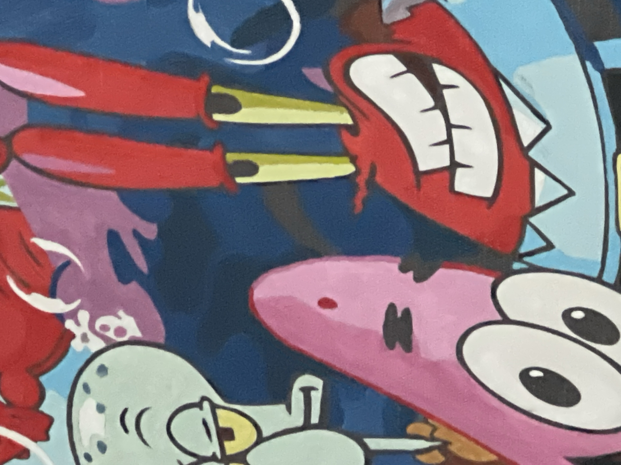 The image is a close-up of a painting featuring cartoon characters from the show SpongeBob SquarePants. The characters visible are SpongeBob SquarePants, Patrick Star, Squidward Tentacles, and Mr. Krabs. SpongeBob and Patrick are in the foreground, with large, expressive eyes. Squidward is partially visible on the left, with a grumpy expression. Mr. Krabs is on the right, smiling widely with his signature buck teeth. The background is a dark blue, possibly representing the ocean, with some abstract shapes in purple and red. The painting appears to be vibrant and colorful, with bold outlines characteristic of the cartoon's style. There is no indication of the city or specific location where this painting is located.