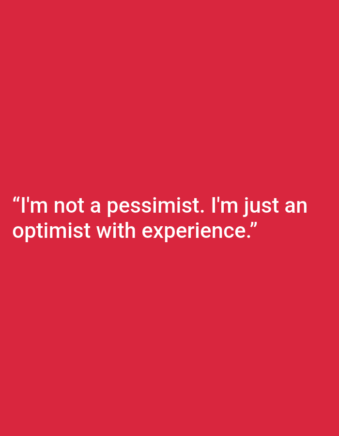 This is a digitally rendered image with a solid red background. White text is overlaid on the lower portion of the image. The text reads: "I'm not a pessimist. I'm just an optimist with experience." There are no people, objects, or environmental details visible in the image. The location in Kępno, Poland is not determinable from the visual information provided.