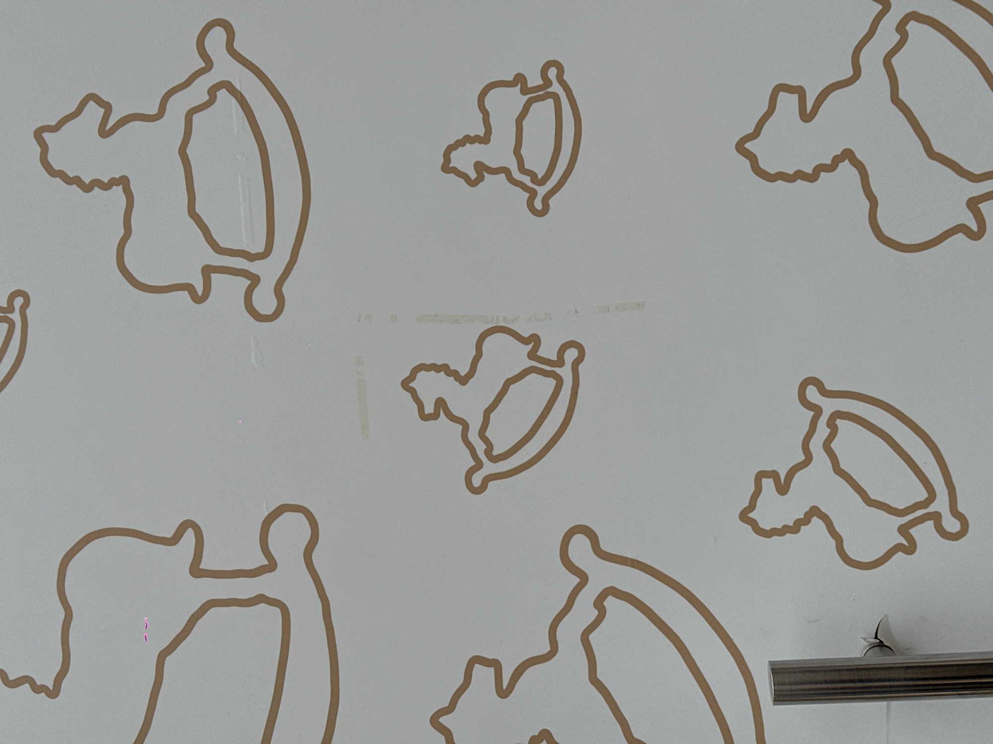 The image shows a close-up of a white surface decorated with outlines of rocking horses in a light brown color. There is no information in the image to indicate that this is in Moscow, Russia. The image includes parts of several stylized rocking horse shapes, arranged randomly across the surface. The image does not depict any people, specific actions, interactions or a defined environment.