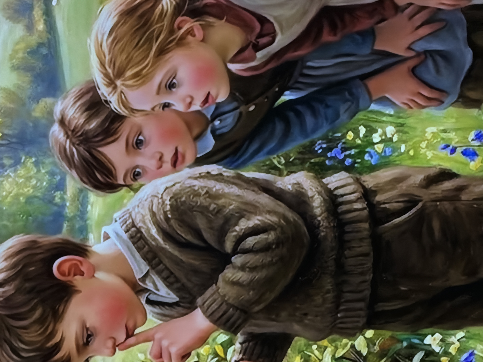 This image is a painting depicting three young children in an outdoor, natural setting, oriented vertically. All three children are positioned looking downwards, appearing to be observing something on the ground with shared curiosity.
The top child, with light blonde hair, fair skin, and rosy cheeks, wears a white shirt under a reddish-brown outer garment. They look intently downwards, their mouth slightly ajar. Immediately below, the middle child, with brown hair and wide, curious eyes, also has fair skin and rosy cheeks. Dressed in a blue shirt and a dark vest or jacket, this child's hands are wrapped around the upper child's back, suggesting close interaction or support.
The bottom child, in the foreground, has brown hair, fair skin, and rosy cheeks. This child is seen with a finger touching their chin or mouth, indicating deep concentration as they peer downwards. They wear a white collared shirt beneath a thick, textured brown knitted sweater.
The background is filled with soft green and yellow hues representing foliage and grass, interspersed with small blue and yellow flowers. The scene evokes a pleasant, sunny daytime environment, suggesting good weather. The children's expressions convey innocence, wonder, and a shared moment of discovery. No visible text is present.