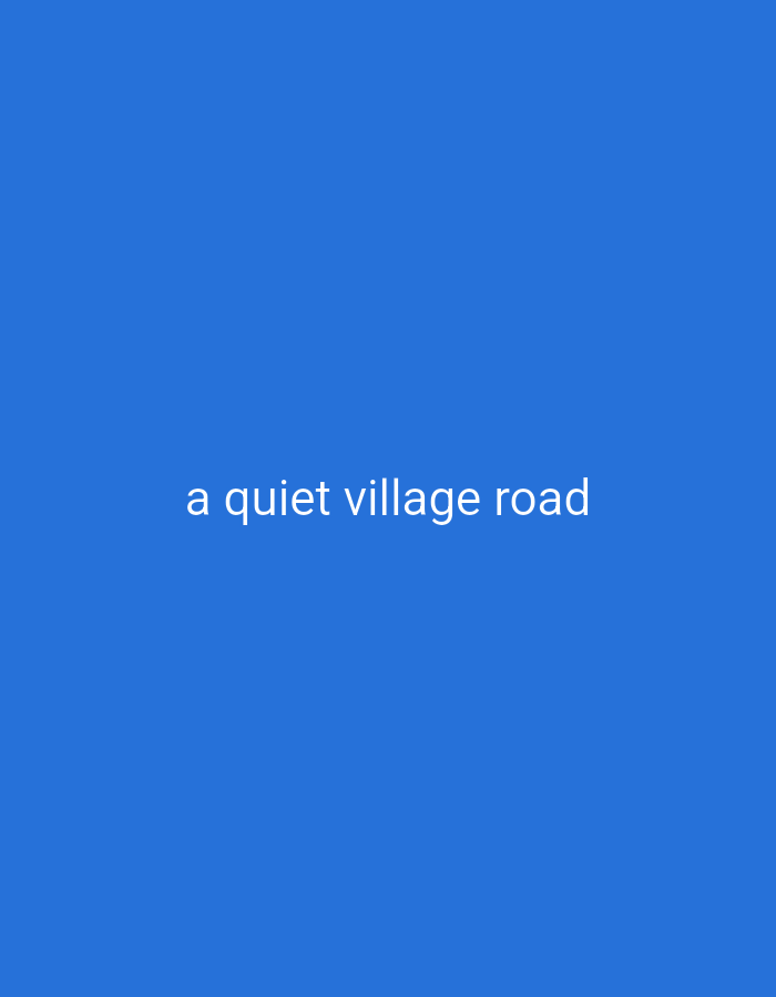 The image is a solid blue background with white text in the center that reads "a quiet village road". There are no people, subjects, objects, actions, or interactions visible. The scene is purely text on a solid color, therefore it does not depict any location in Cilegon, Indonesia, or any other place.