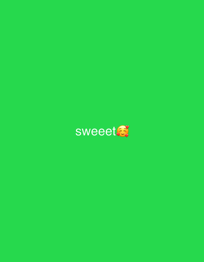 The image is a static, horizontally oriented shot with a plain, vibrant green background. Centered horizontally and positioned in the lower half of the frame, the word "sweeet" is displayed in white, sans-serif text. To the right of the text, there is a smiling face emoji with blushing cheeks and hearts floating around it, also in white. The green background suggests a digital or abstract presentation rather than a real-world scene, making it impossible to determine any location within Tbilisi, Georgia. There are no people, objects, actions, or interactions depicted.