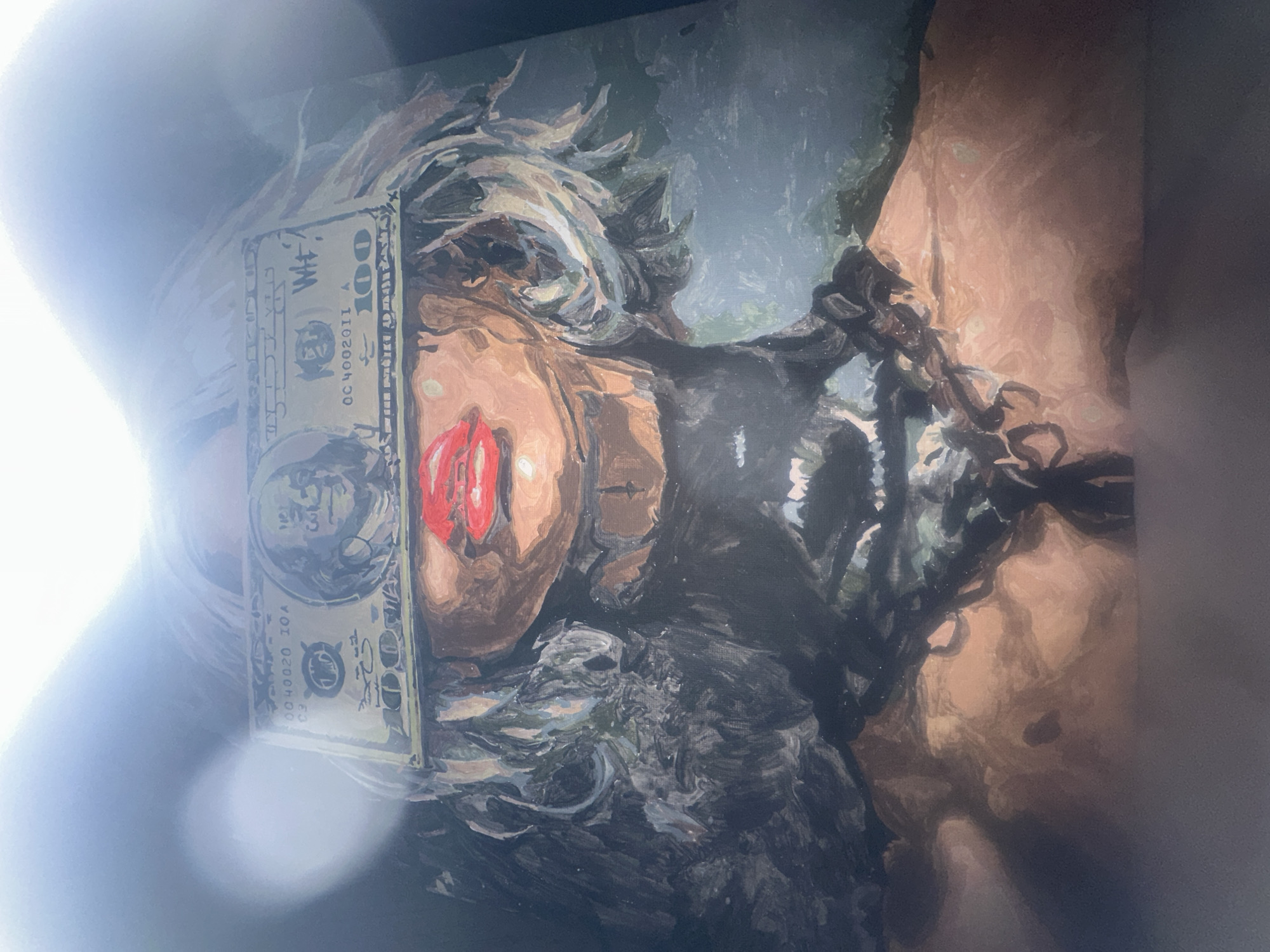 The media file is a photograph of a painted artwork, which is depicted in a rotated orientation. The painting features a figure, likely a person, with their eyes obscured by a $100 bill. The visible part of the face shows prominent red lips and stylized, somewhat disheveled hair rendered with thick brushstrokes.
To the right side of the painting (which would be the figure's neck or shoulder area if oriented correctly), a heavy chain or restraint is visible, suggesting themes of binding or captivity. The background is abstract and dark, comprising muted shades of green and grey, contributing to an intense or somber atmosphere. The artwork's style is painterly, characterized by visible, textured brushstrokes.
The central activity or theme conveyed by the painting is a commentary on materialism, power, or being "blinded by money," underscored by the $100 bill covering the eyes and the presence of chains. The color palette includes warm skin tones, a striking red for the lips, the iconic green of the dollar, and dark tones for the background and chains.
Notable visible text on the $100 bill includes the denomination "100" and a serial number "OC 400201I A". Additionally, partial text resembling "WT" or "WH" is visible near Benjamin Franklin's portrait on the bill. The photograph itself has a significant bright glare on the left side, obscuring some details of the artwork.