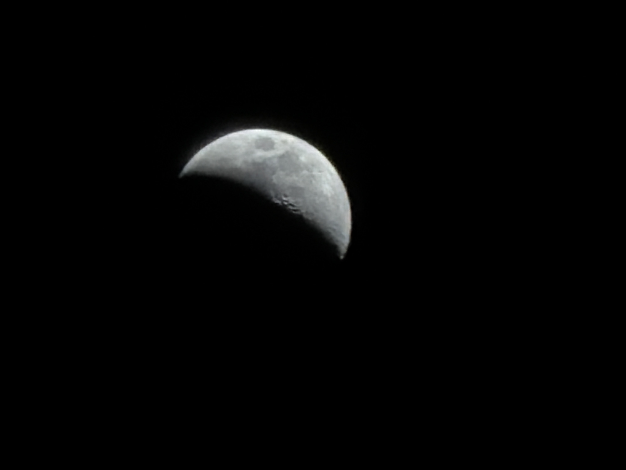 The image shows a crescent moon against a black sky. No other information or details are discernible. The image provides no data to locate the scene in Izhevsk, Russia.
