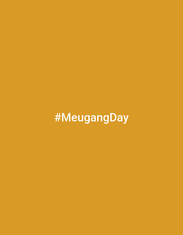 The image is a solid mustard yellow background with the text "#MeugangDay" in white in the center. There are no other elements in the image. The image does not provide sufficient information to determine a location in Kutaglumpang, Indonesia or any details about people, subjects, objects, actions, interactions, or the environment.