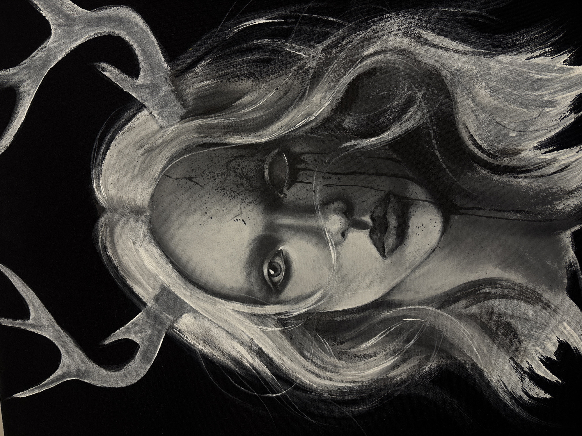 A black and white portrait of a woman with flowing hair and antlers emerging from her head. Her face is slightly cracked, with dark lines emanating from one eye as if she is crying. The background is black. There is no indication of this image being located in the city of Krasnoyarsk, Russia.