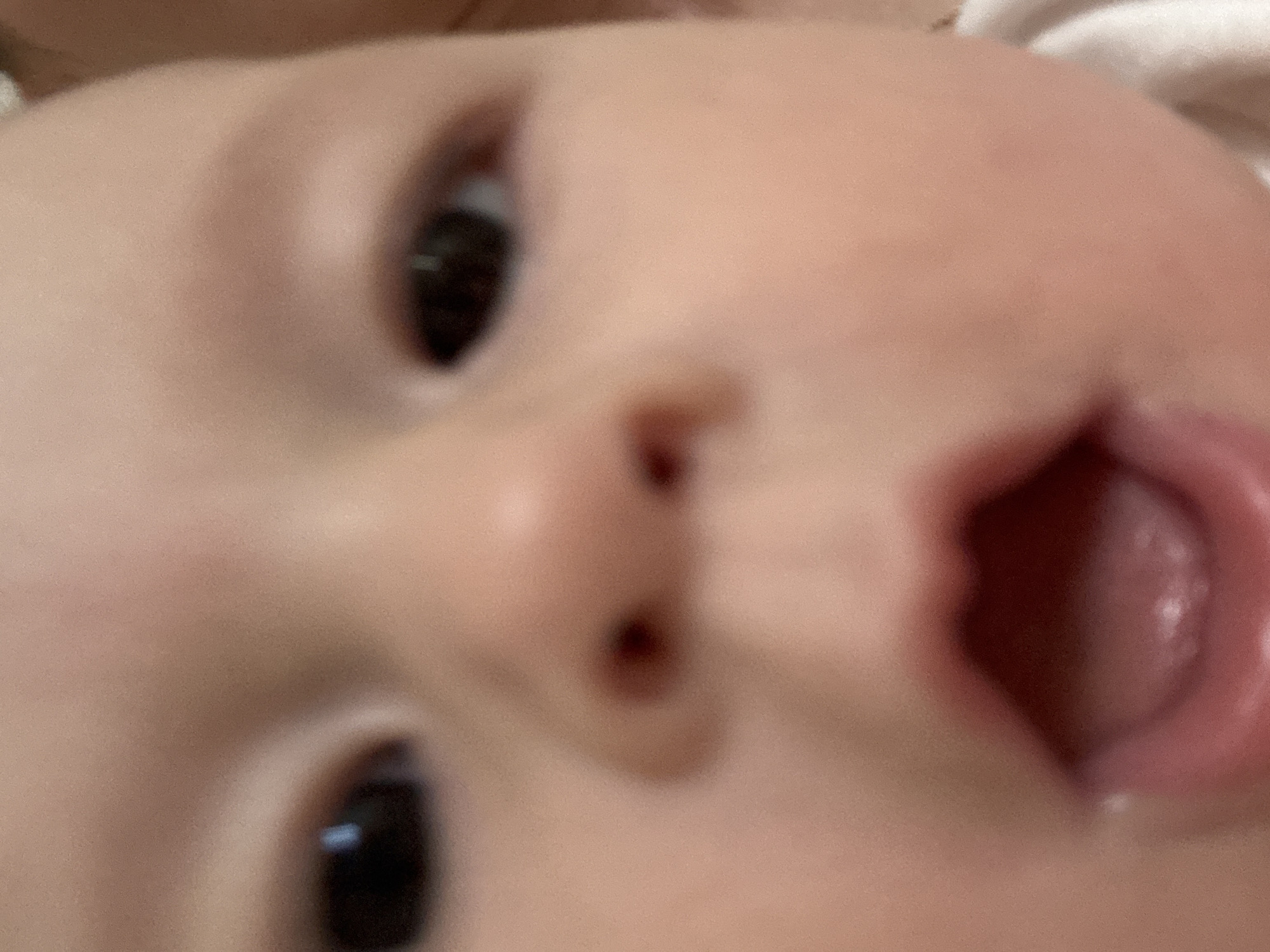 The image shows a close-up of a baby's face. The baby has brown eyes and an open mouth. No information indicates the location is Sochi, Russia.