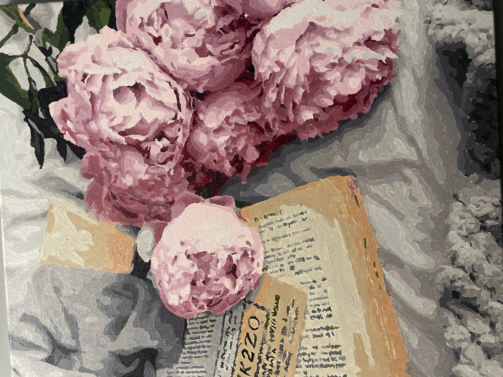 This is an oil painting depicting a vibrant still-life composition. The primary subjects are a large bouquet of lush pink peonies, centrally arranged. The flowers showcase varying shades of pink, from light blush to deep magenta, with visible brushstrokes creating texture and depth in their petals. Green leaves and stems are interspersed among the blooms.
Beneath and around the peonies are several old, yellowish-brown papers or book pages, crumpled and partially layered. These papers feature illegible script, resembling ancient text or artistic scribbles, adding to the antiquated charm of the scene. On one prominent piece of paper, the alphanumeric sequence "K220" is clearly visible. To the left of the flowers and papers, a block of light-colored material, possibly cheese or butter, rests on a similar paper-like surface.
The entire arrangement is set against a textured background of rumpled fabric, rendered in various shades of grey and white, suggesting a tablecloth or blanket. The painting style is characterized by distinct, broad brushstrokes and blocky areas of color, giving it an impressionistic quality. The lighting is soft, creating subtle highlights and shadows that emphasize the texture of the petals and folds in the fabric.
No specific activity is taking place; it's a static still life. The scene evokes a sense of tranquility and domestic comfort. There are no explicit visual cues within the painting itself to suggest the location is Sochi, Russia.