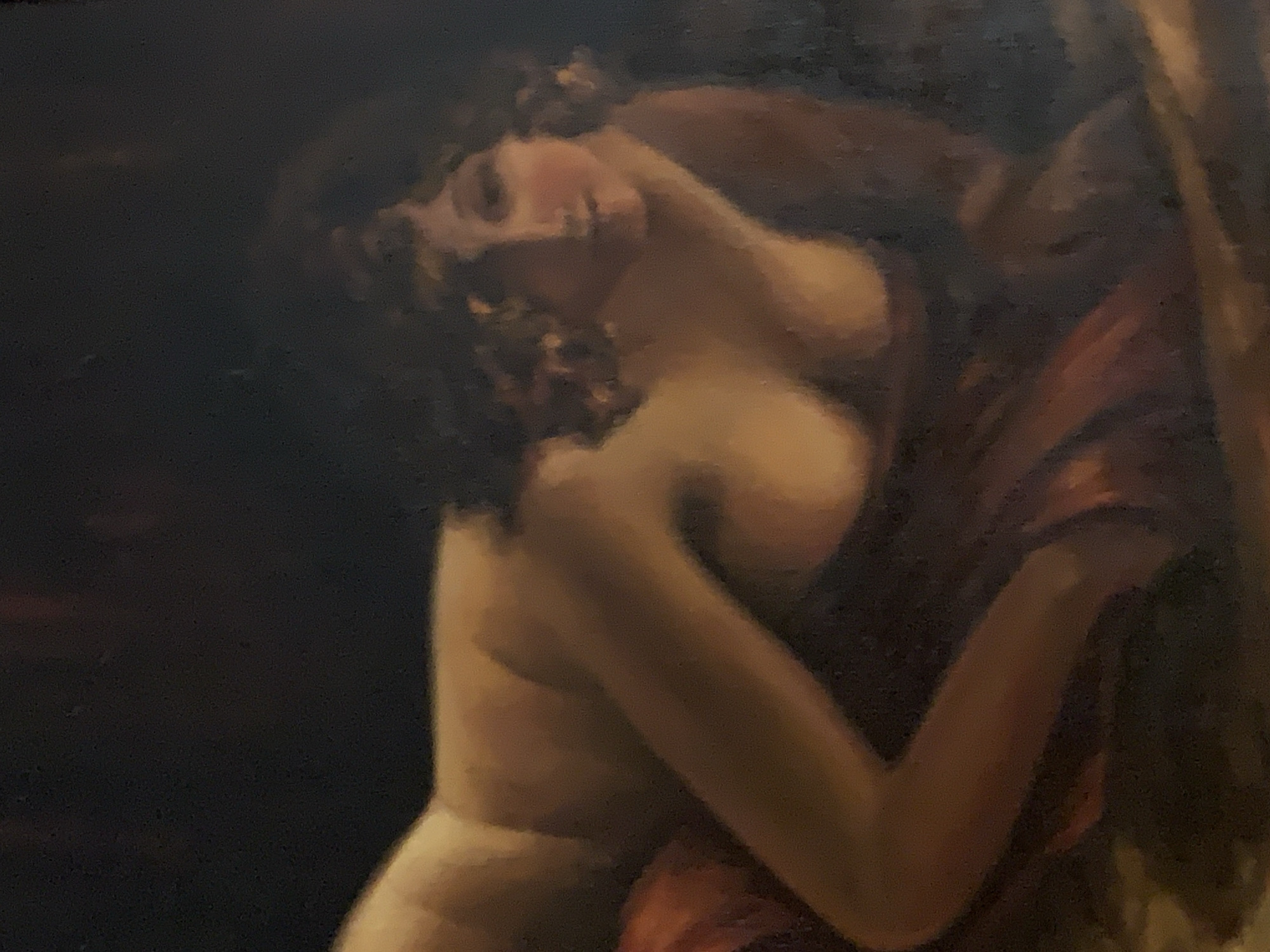 This is a painting of a nude woman reclining on her side. She is facing left, with her head turned towards the viewer. Her hair is dark and curly, and she has a fair complexion. She is partially draped in a red cloth, which covers her lower body and arm. The background is dark and indistinct, with hints of red and brown. The lighting is soft and diffused, casting a warm glow on the woman's skin. The style of the painting is realistic, with a focus on form and color.