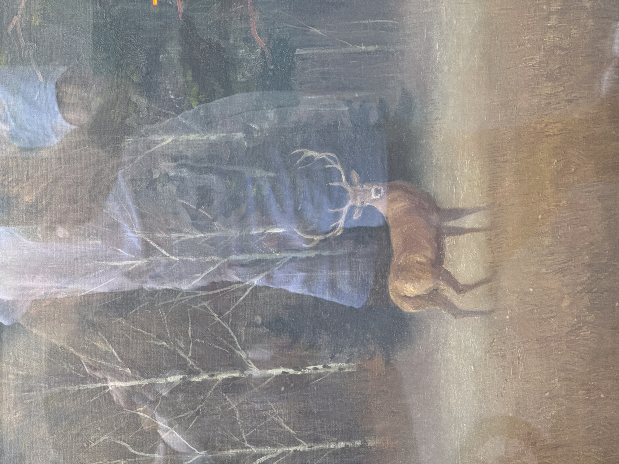 This is a painting that appears to depict a rural or forest scene. A deer with large antlers is prominently featured, facing towards the right and appearing to be drinking or sniffing at something on the ground. The deer is rendered in earthy tones of brown and tan.
To the left of the deer, a large, draped form is visible, rendered in shades of blue and white. It's unclear whether this represents clothing, fabric, or a natural element like a large rock or hill. There's a sense of a human presence, possibly a person partially obscured or a figure in the background, suggested by the shape and the light blue of the draped form. Bare trees with thin, white branches are scattered throughout the scene, hinting at a cooler season like late autumn or winter. The background is a muted mix of greens and browns, suggesting foliage and earth.
The overall lighting suggests it might be daytime, possibly overcast or at dusk, given the soft illumination. The scene has a peaceful, almost serene quality. The brushstrokes are visible, giving the painting a textured, traditional feel. There is no visible text in the image.