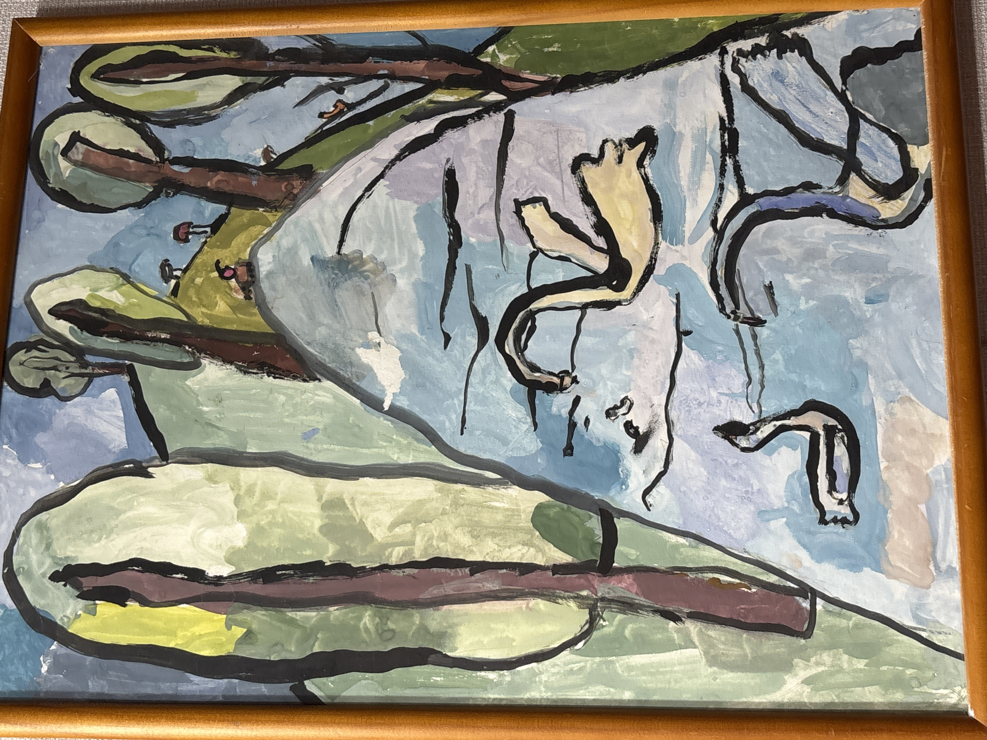 The image is a painting in a wooden frame, depicting a stylized landscape with a body of water in the foreground. Two swans are visible in the water; one is larger and a pale yellow with black outlines, while the other is smaller, black and white, and positioned further away. The background features rolling hills with simplified trees and a blue sky. The artistic style is abstract and uses broad brushstrokes and bold outlines. The painting is an artwork and not a photograph of a specific location. There is no information within the image that suggests a connection to the city of Pavlodar, Kazakhstan.