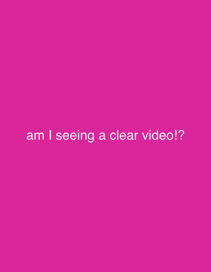The image displays a solid magenta background. Centered horizontally in the lower middle portion of the frame, white text reads: "am I seeing a clear video!?" No people, subjects, or other objects are depicted, nor are any actions or interactions observable. The environment consists solely of this uniformly colored background and text. This scene is described as being in the city of Wealden, United Kingdom.